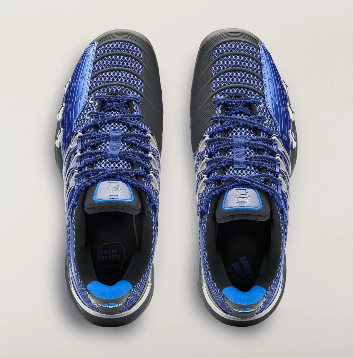 Top-down view of blue pair with frayed laces, Brain Dead insole logo, blue heel pads, x Brain Dead