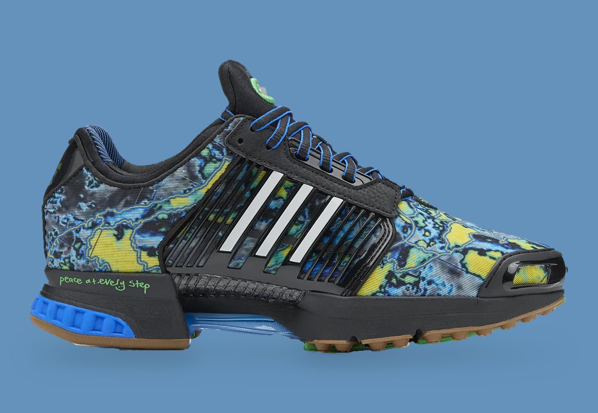 Lateral view of sneaker with marbled blue and yellow print, black cage, white stripes, blue heel, Climacool x ADWYSD
