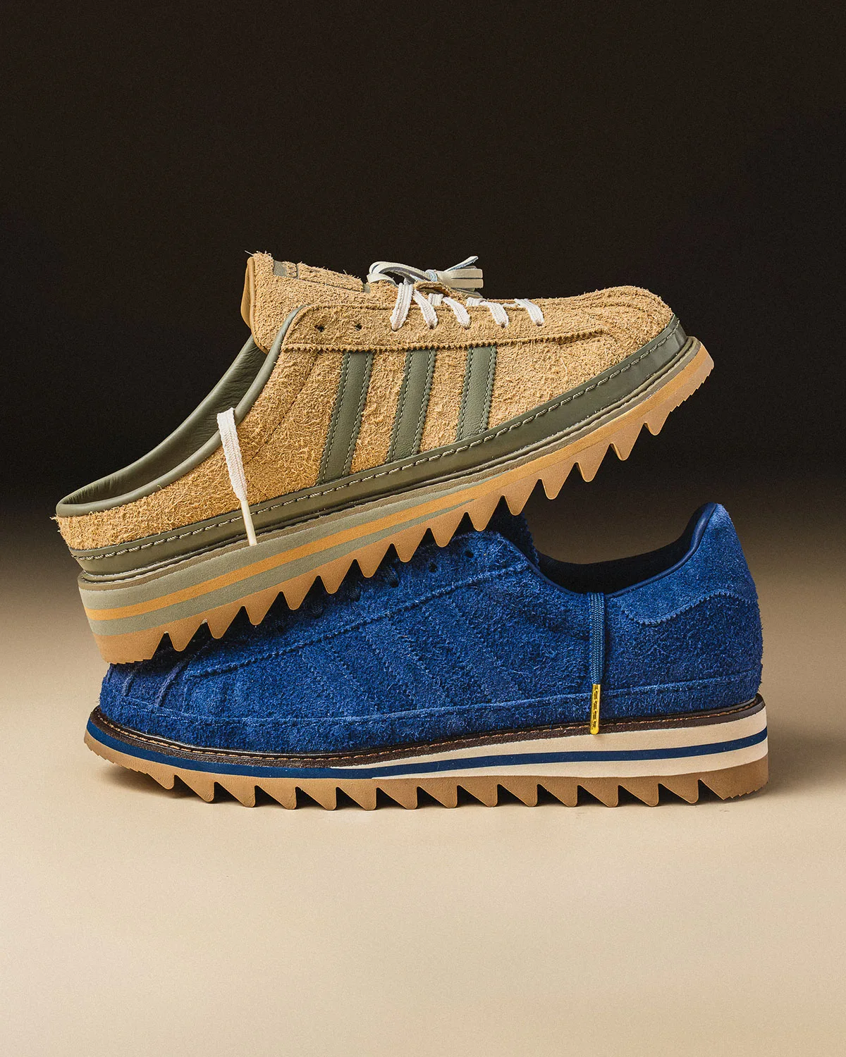 Side view of tan mule stacked on blue suede sneaker, both with sawtooth soles, dark backdrop, Mule x CLOT
