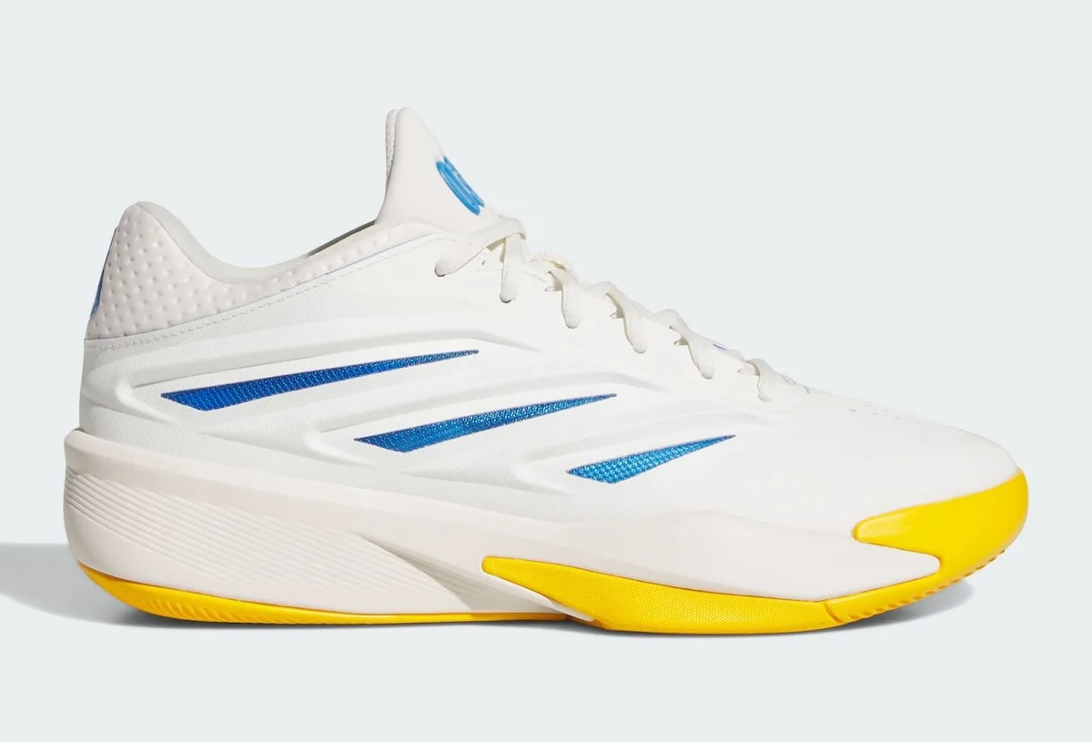 Lateral view of white sneaker with three blue stripes and bright yellow midsole accents, Wagner Brothers
