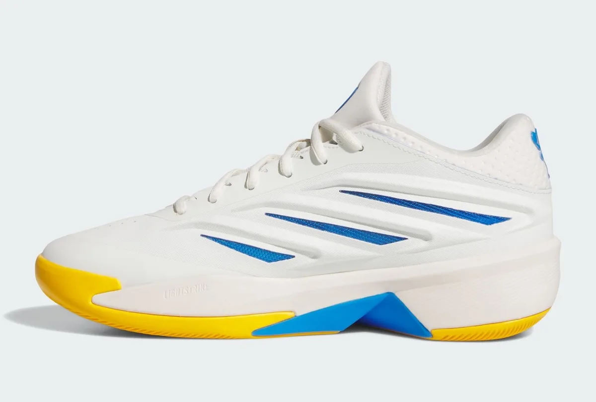 Medial view of white sneaker with blue stripes, yellow outsole and a blue heel wedge, Wagner Brothers