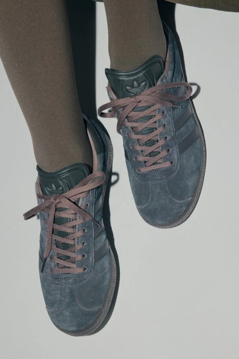 Top-down on-foot view of gray-blue suede sneakers with mauve laces and trefoil heel tab, Charcoal Gray