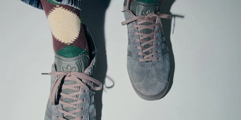 Top-down on-foot view of gray suede sneakers with mauve laces and argyle socks, Charcoal Gray