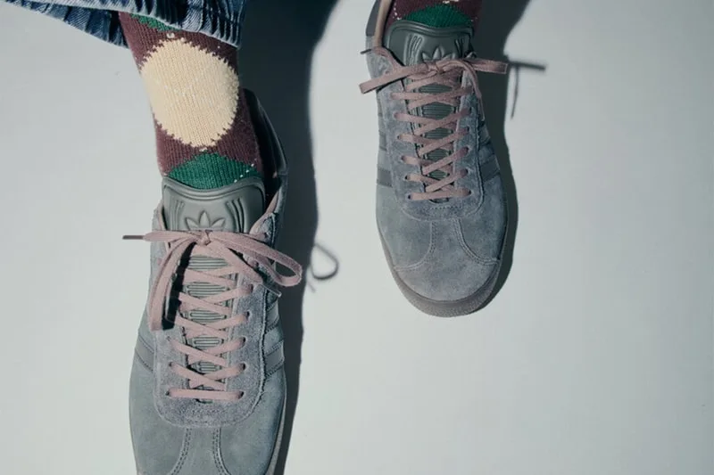 Top-down on-foot view of gray suede sneakers, pink-mauve laces, maroon and green argyle socks, Charcoal Gray