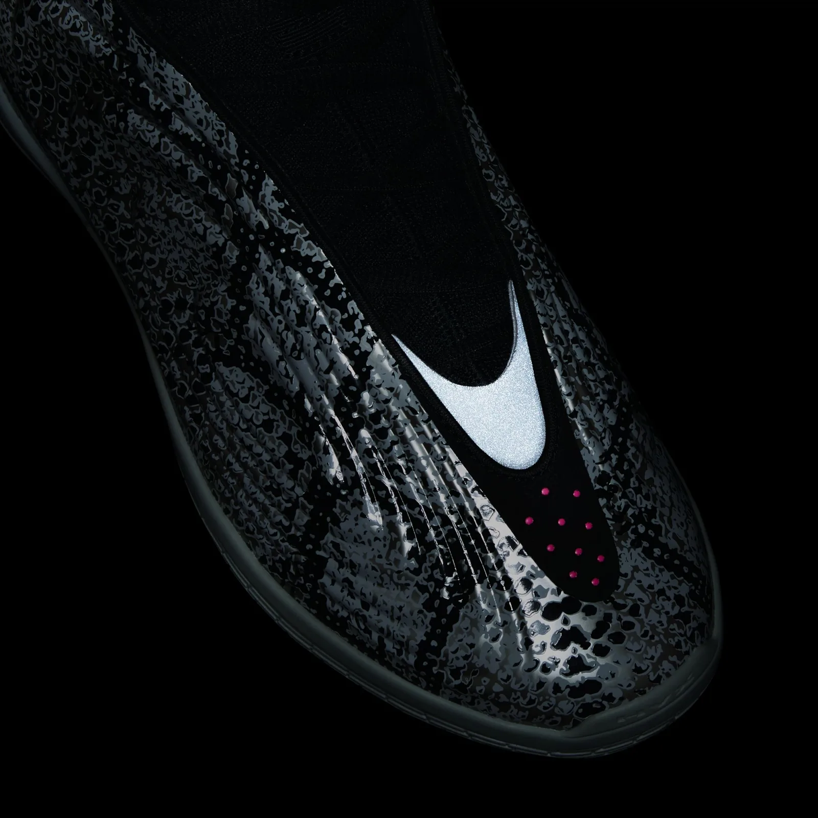 Toe detail in the dark, reflective white swoosh-shaped panel and pink dots on black, Snakeskin
