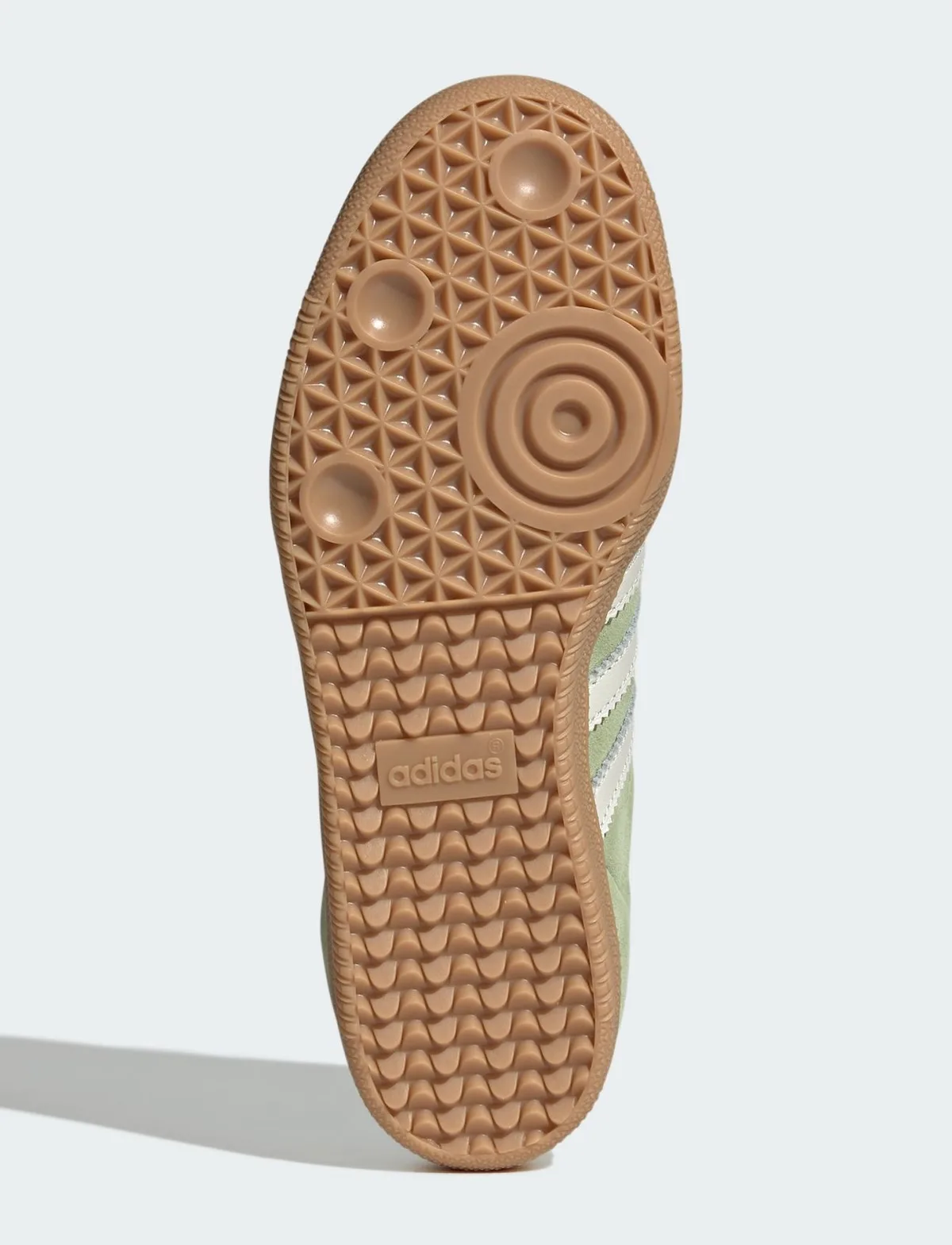 Outsole view of gum rubber with triangle pattern, circular pods and adidas logo, Matcha