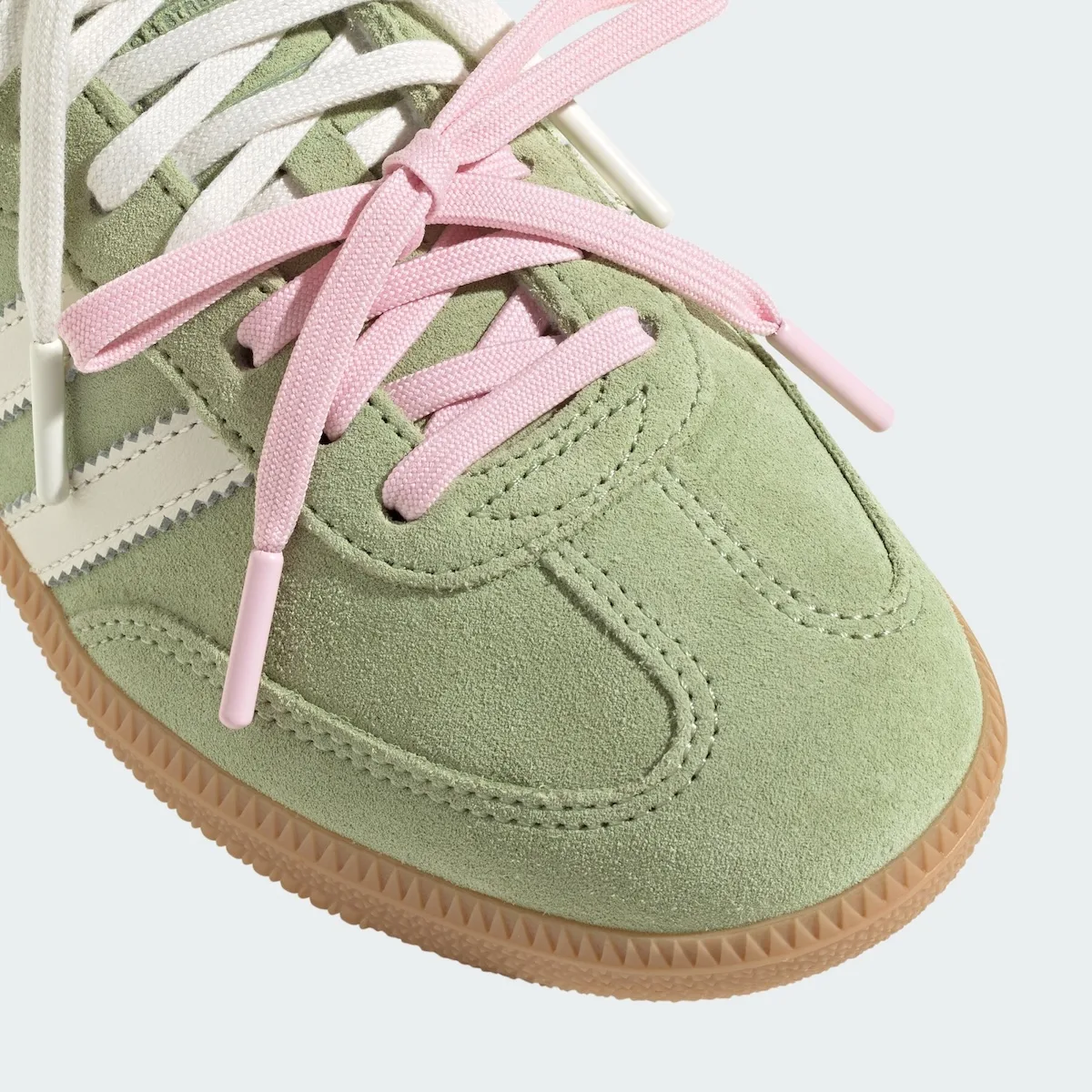 Toe detail of green suede with pink laces, pink aglets and gum sole, Matcha