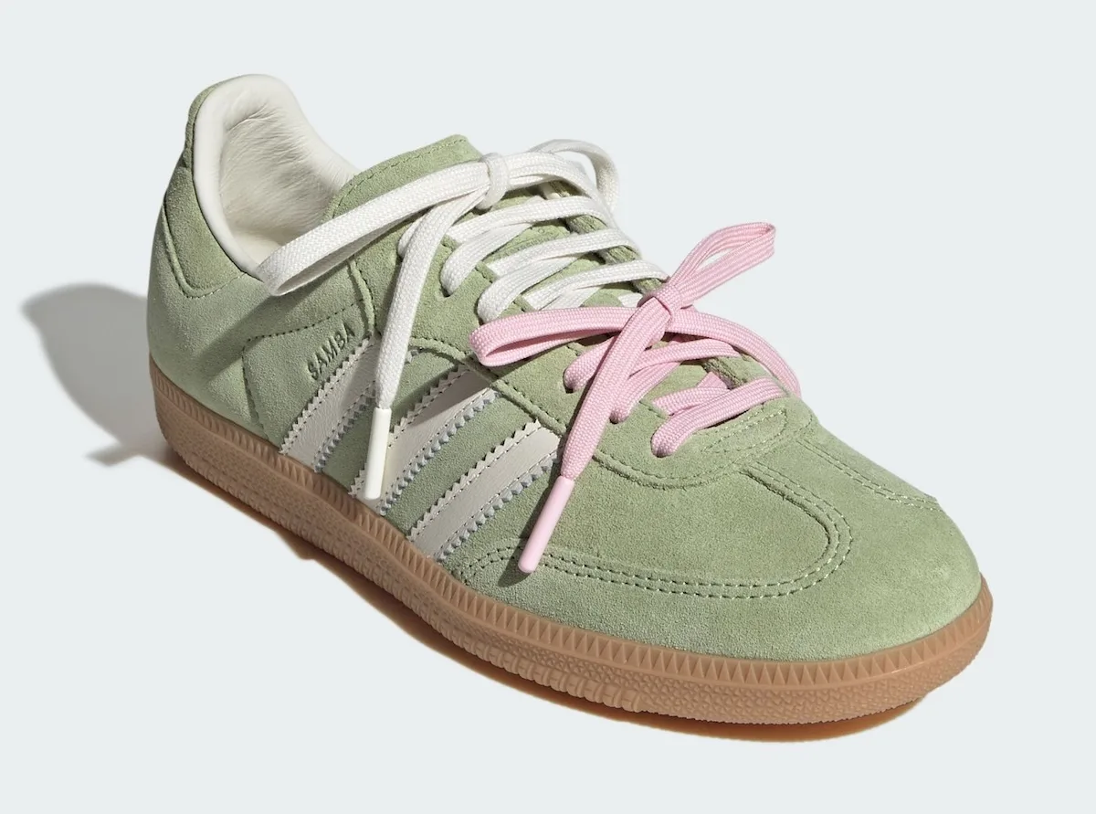 Three-quarter toe view of green suede sneaker with pink and cream laces, gum sole, Matcha
