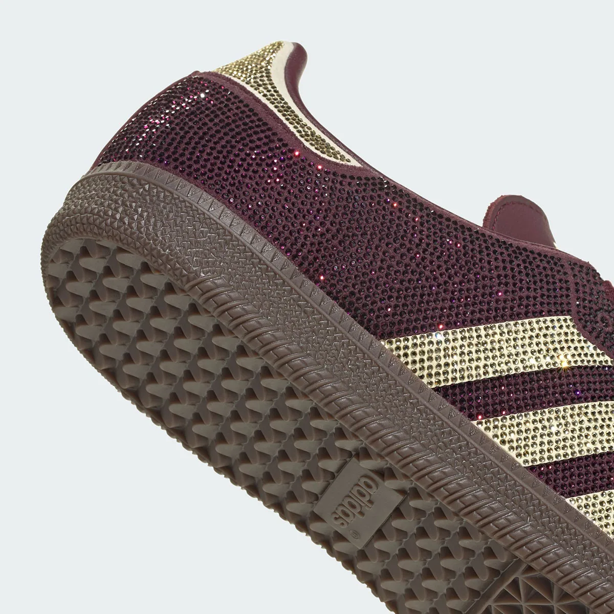 Detail of heel, sparkling maroon crystals, gold stripes, gum sole with adidas logo, Rhinestone