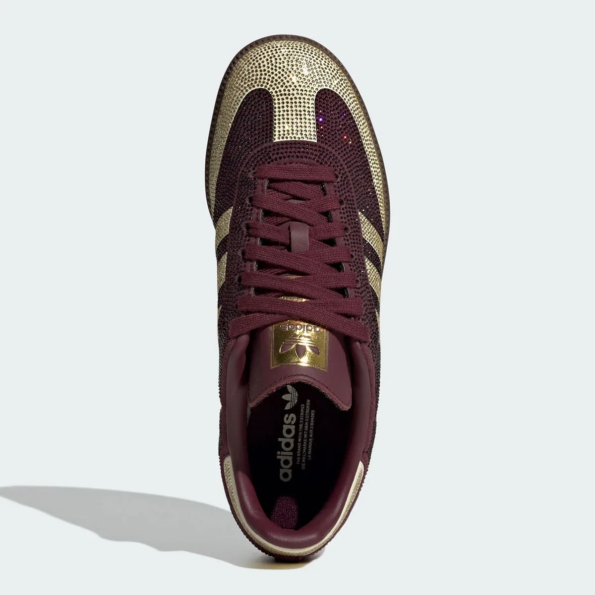 Top-down view, maroon laces, gold crystal toe, gold tongue label, adidas insole text, Rhinestone