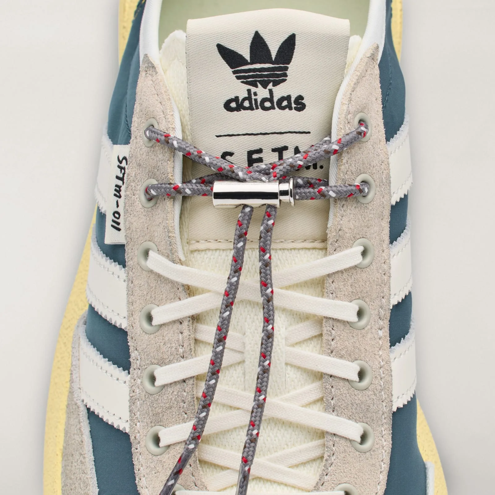 Lacing detail with gray flecked cord, silver toggle and adidas tongue logo, Wild Teal