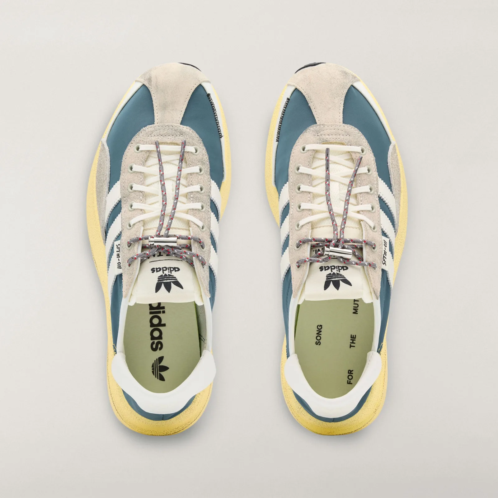 Top-down pair with cream laces and gray cords flecked red and white, Wild Teal