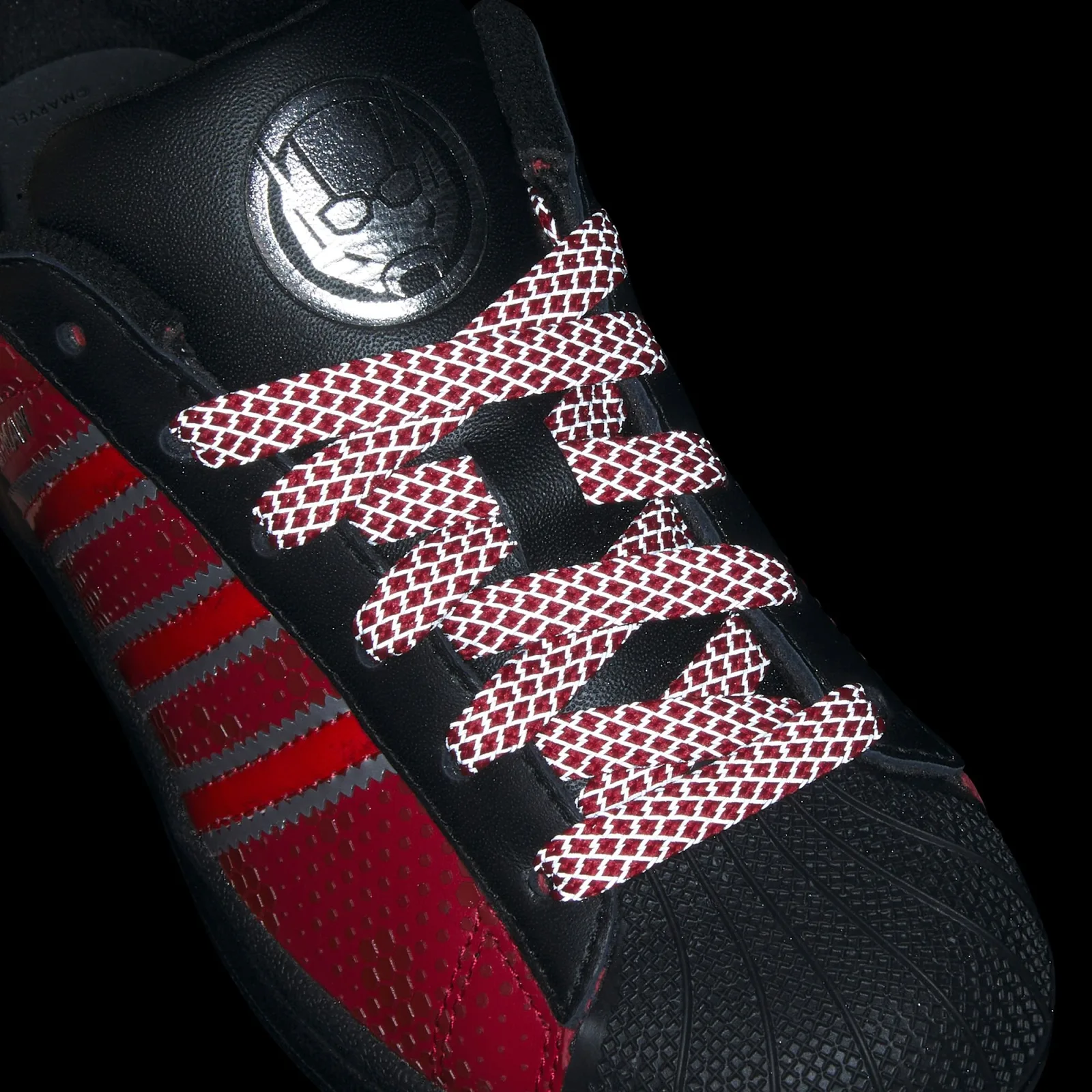 Lace detail against black with bright reflective lattice and silver tongue emblem, Ant Man