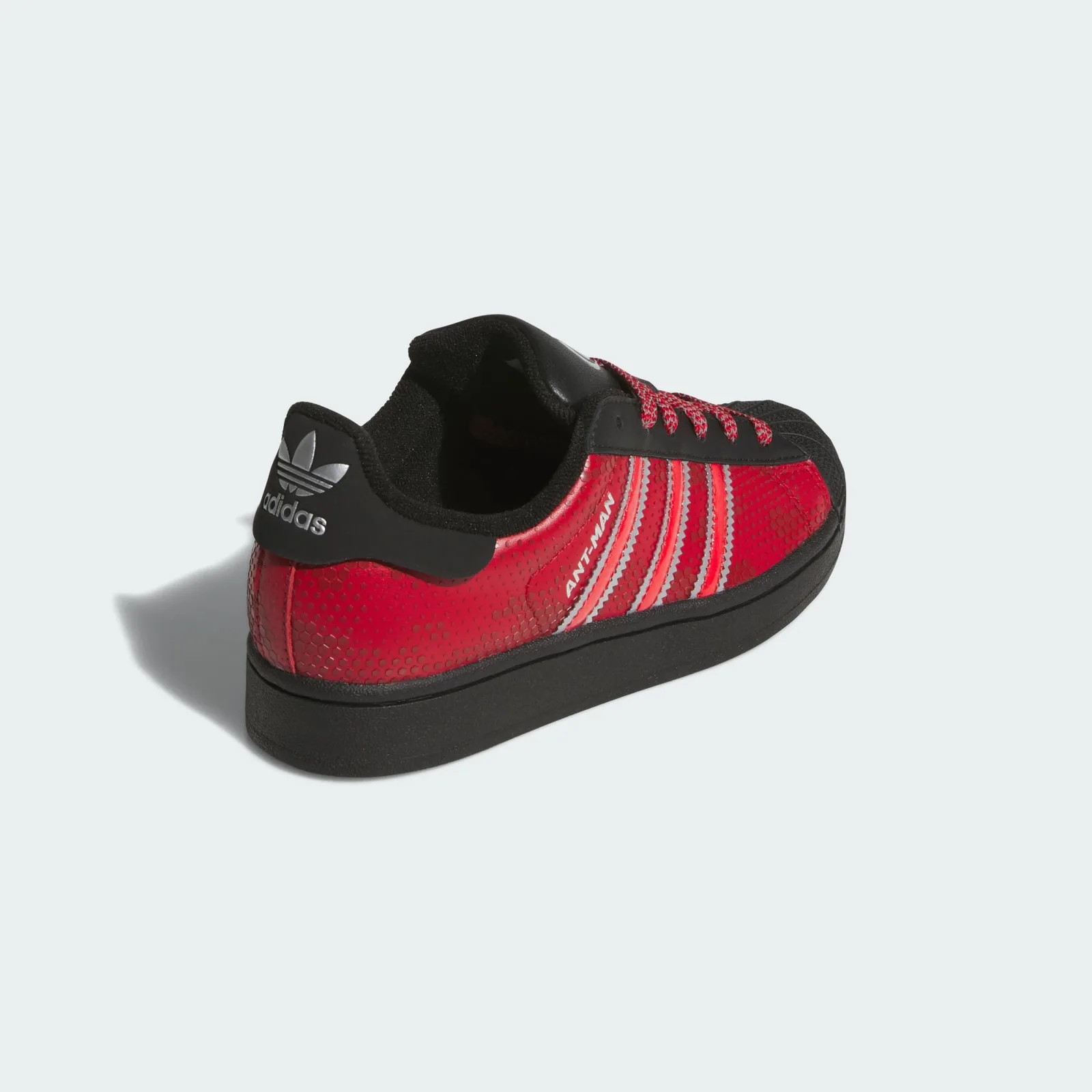 Rear three-quarter view with a silver adidas logo on the black heel tab, Ant Man
