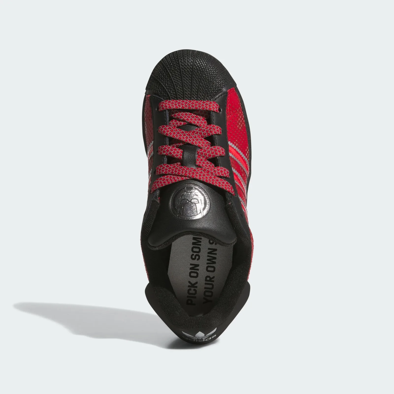 Top-down view with red patterned laces and a silver Ant-Man tongue emblem, Ant Man