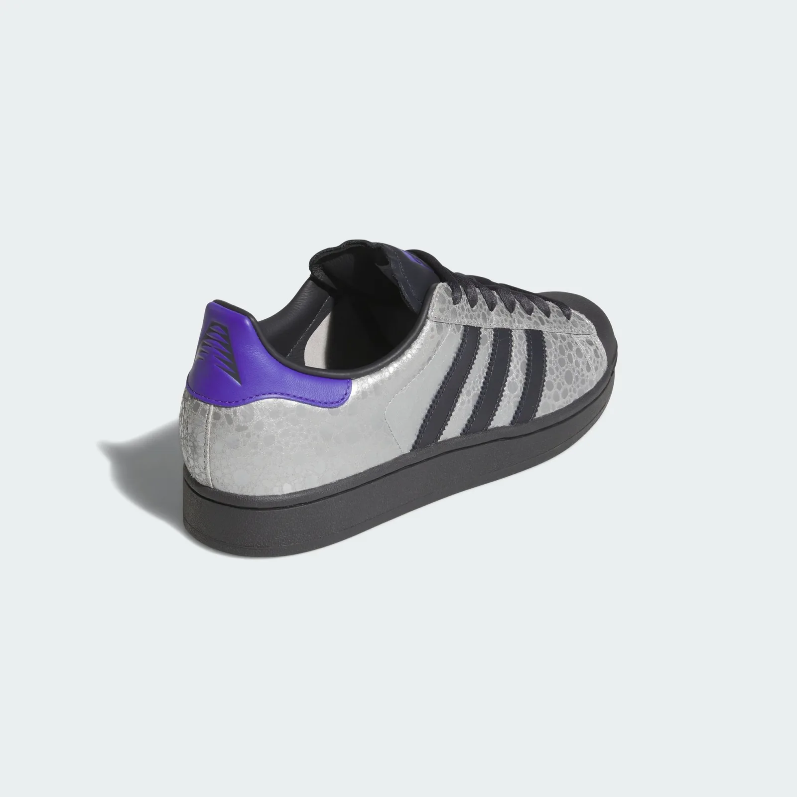 angled heel view, purple heel tab, black sole, silver crackled upper, Stone