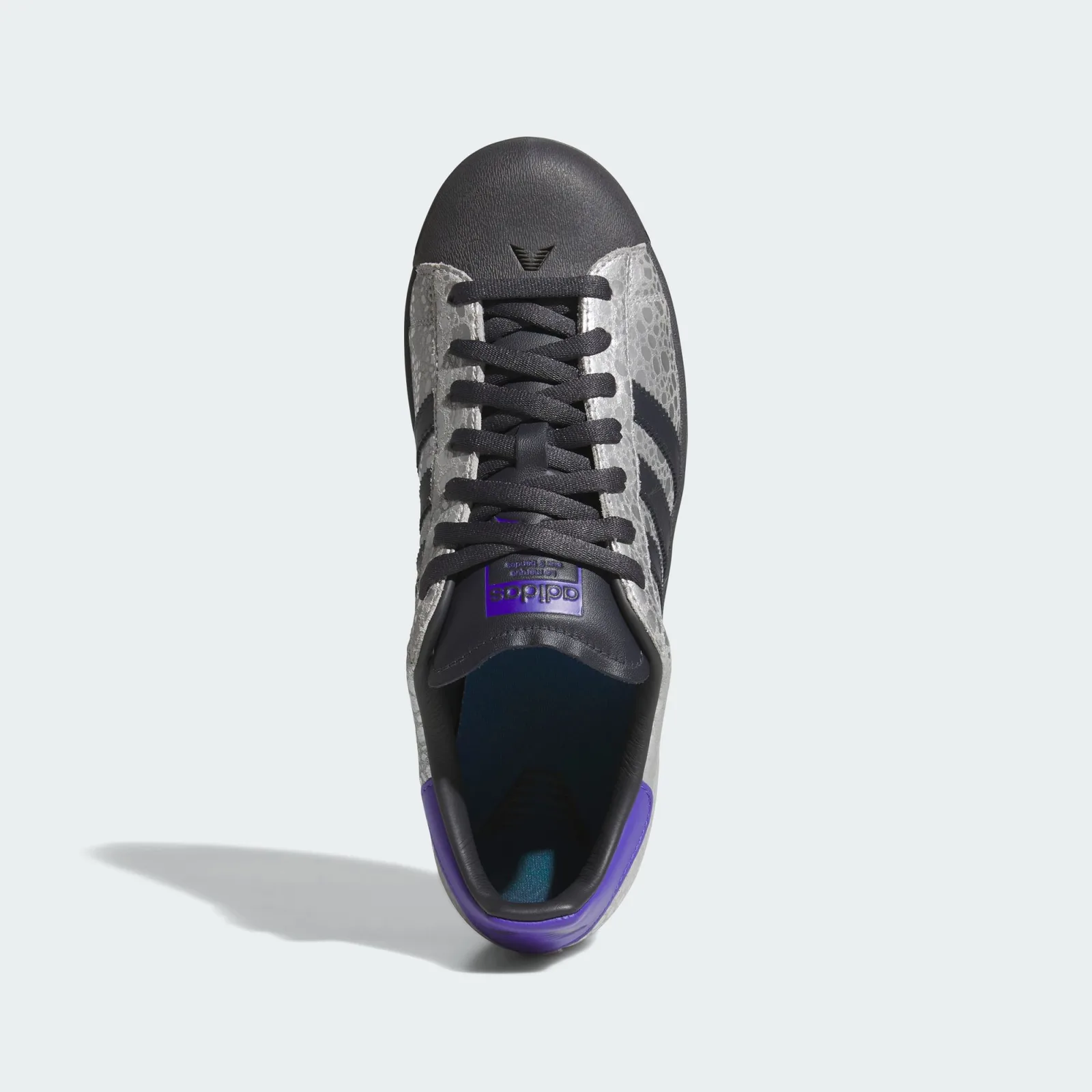 top-down view, black toe cap, purple sockliner, adidas wordmark on tongue, Stone