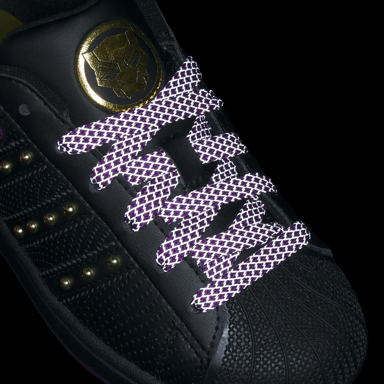 Lace detail against black with a bright white lattice pattern over purple, Black Panther