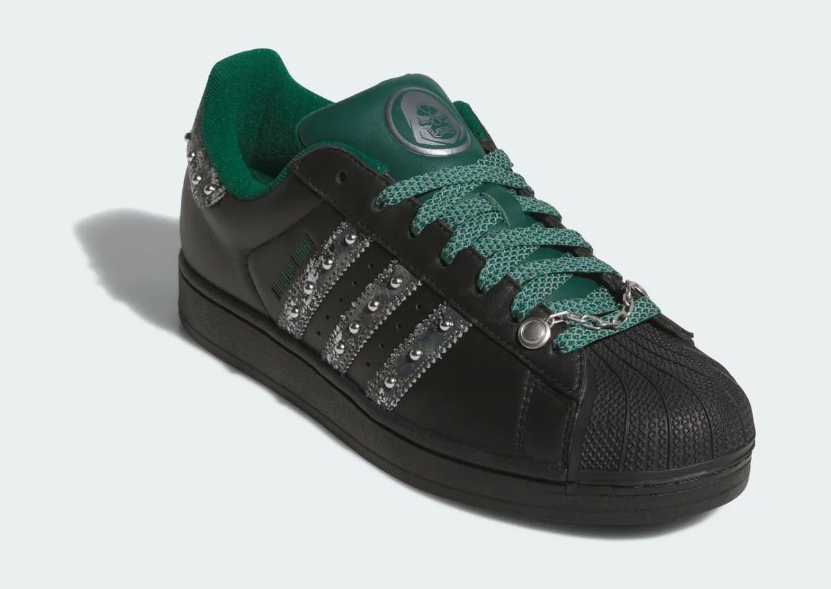 Front three-quarter view with black shell toe and studded silver stripes, adidas Superstar x Marvel “Doctor Doom”