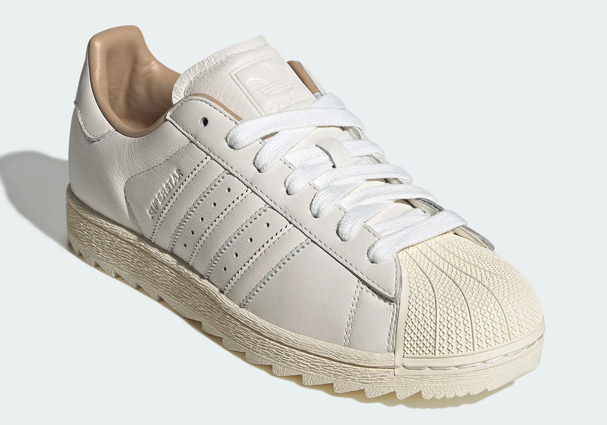 Three-quarter toe view with white laces, cream shell toe, tan heel lining and zigzag midsole, Core White