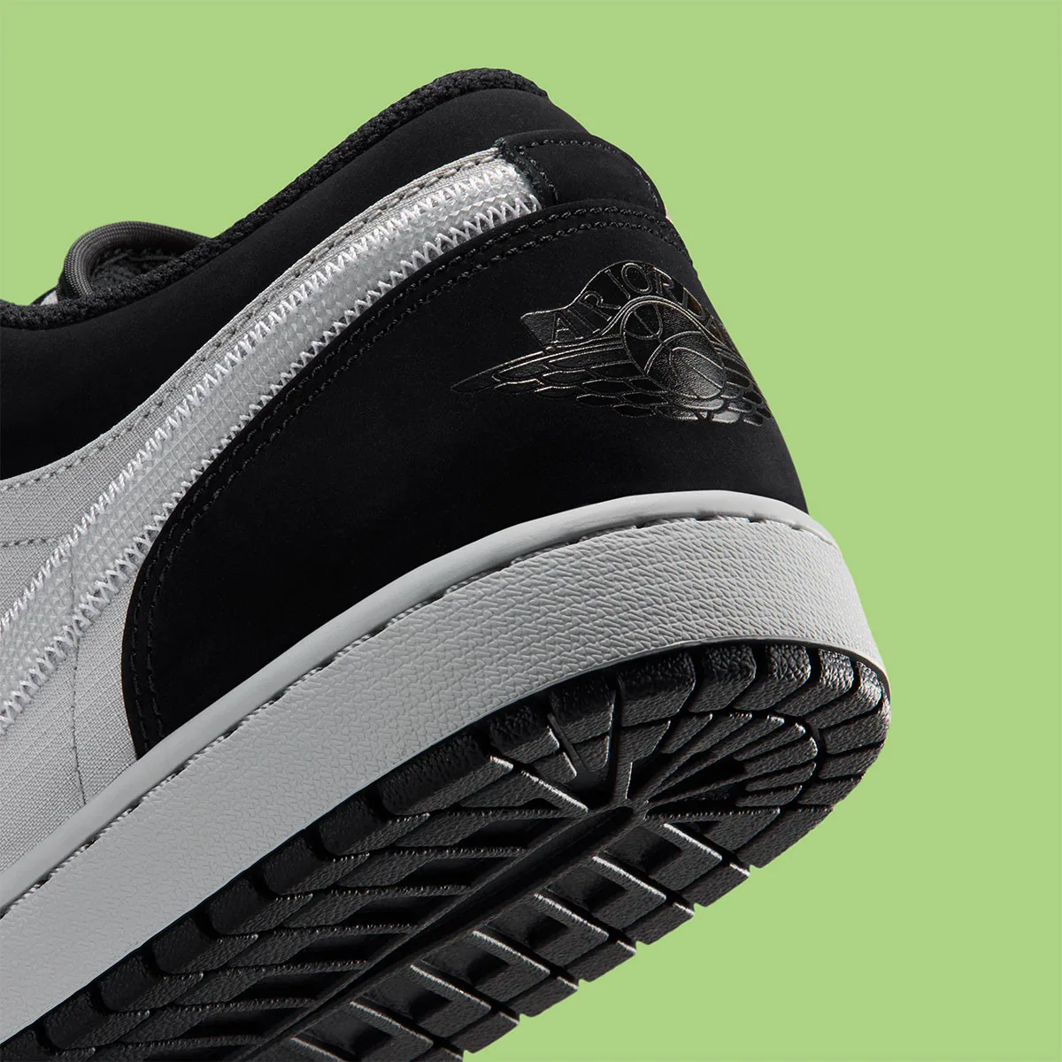 Detail of heel with embossed Air Jordan wings logo on black nubuck, grey midsole and black outsole, Light Smoke Grey