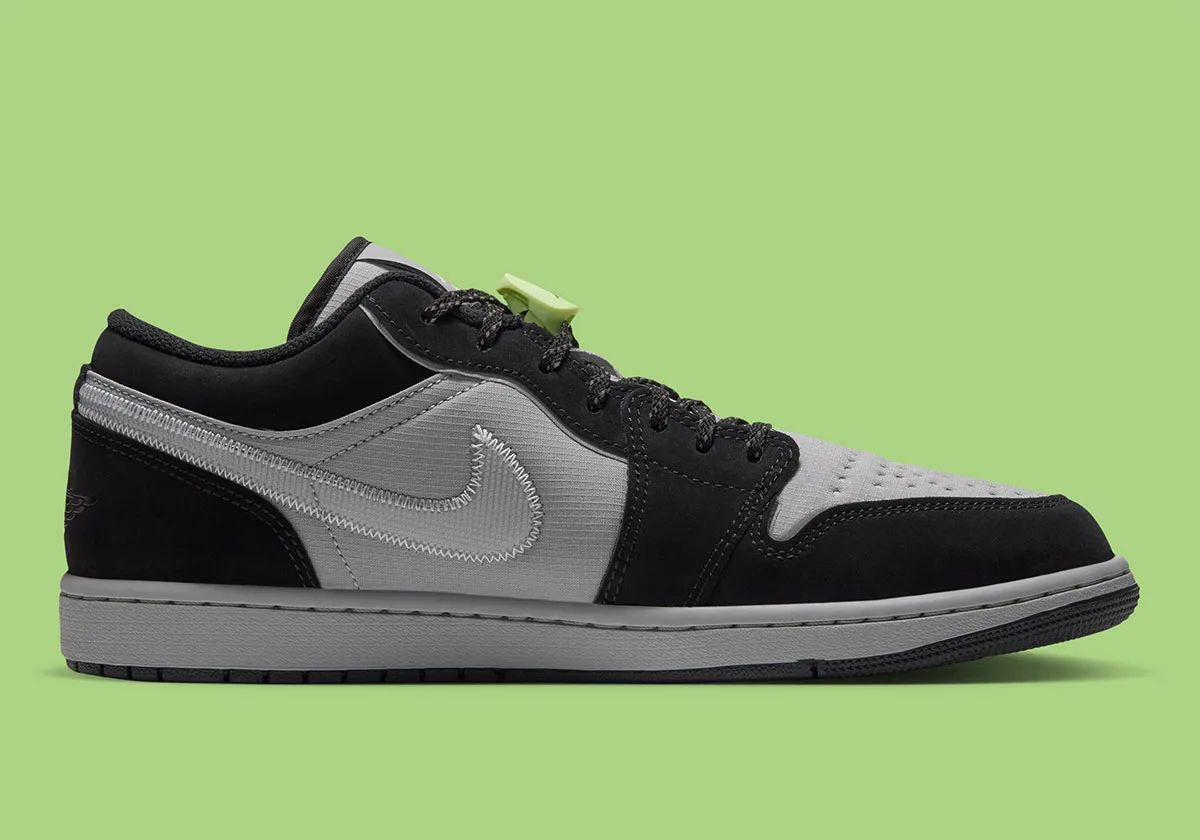 Medial view of grey ripstop and black nubuck sneaker with stitched swoosh against green background, Light Smoke Grey