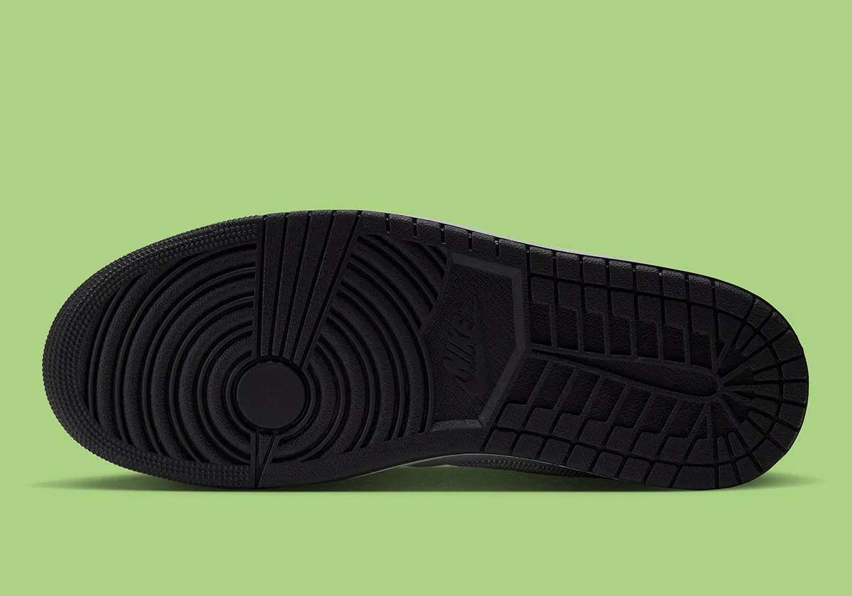 Outsole view of black rubber sole with circular pivot pattern and herringbone traction on green background, Light Smoke Grey