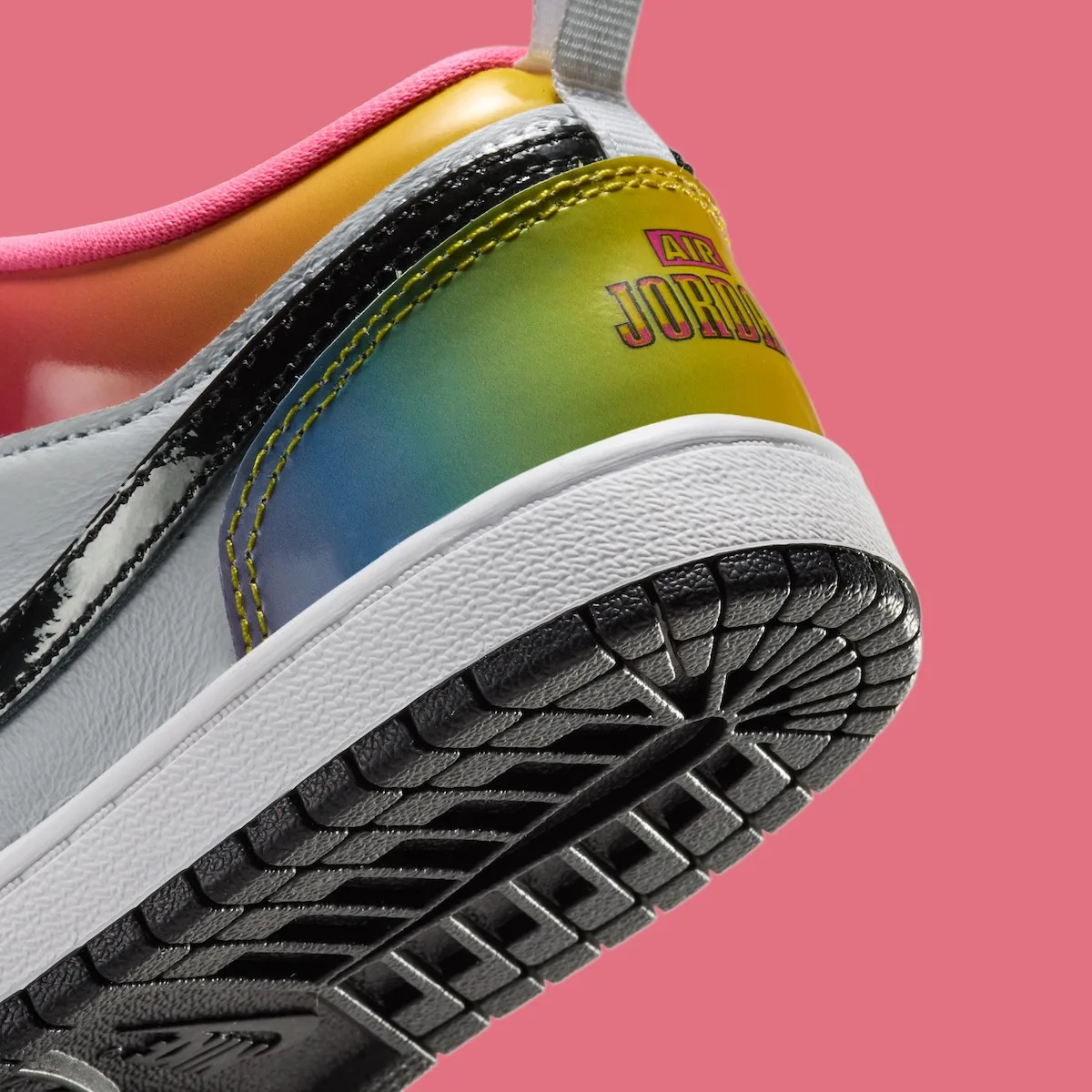 Heel detail with rainbow gradient tab, pink Air Jordan text, white midsole and black outsole, Lola Bunny