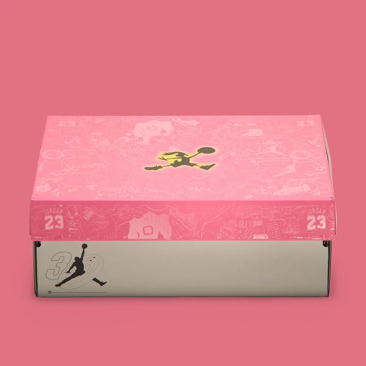 Packaging: shoe box with pink printed lid, yellow cartoon Jumpman and 23 graphics, Lola Bunny