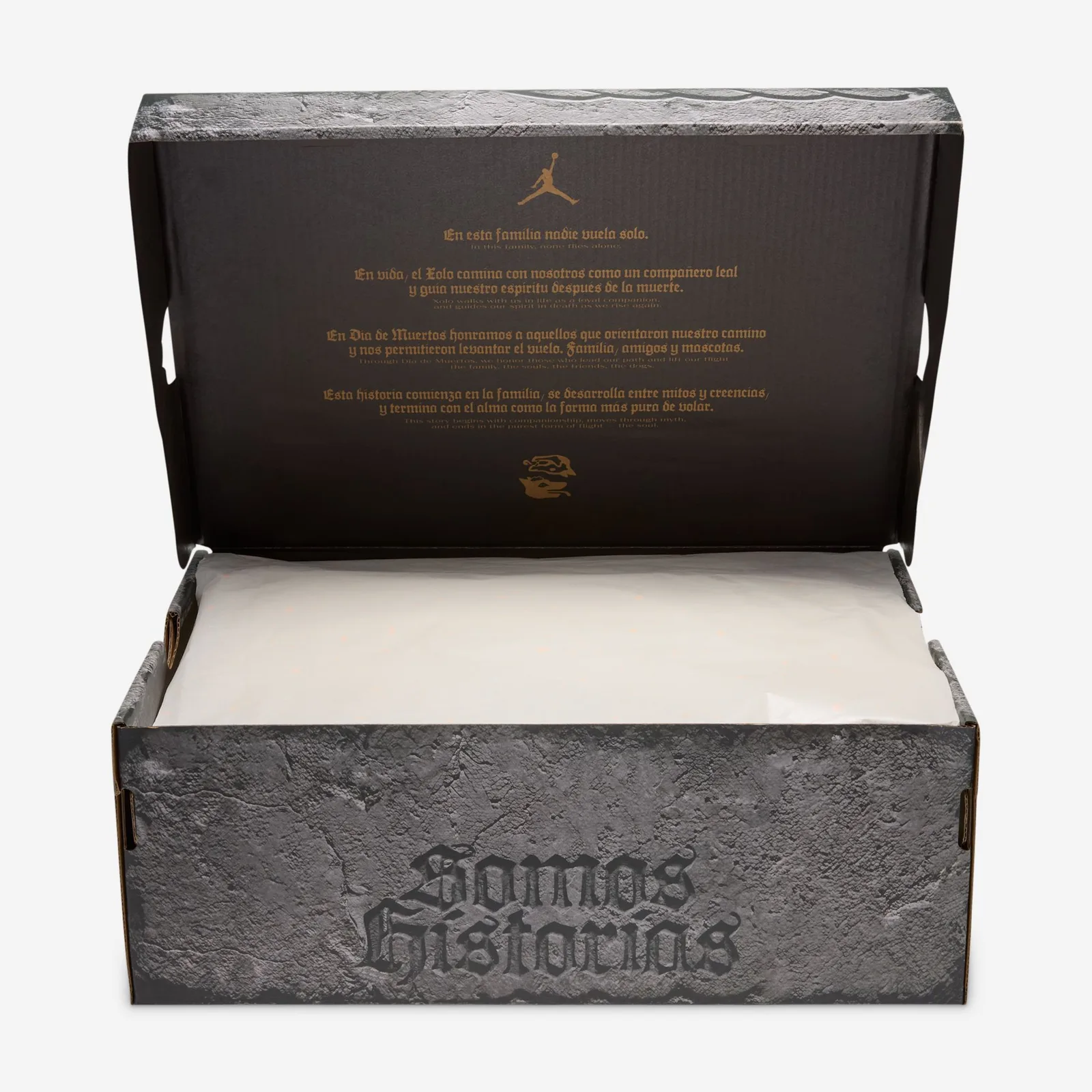 Open stone-textured shoe box, Spanish and English text inside lid, white tissue paper, Somos Historias