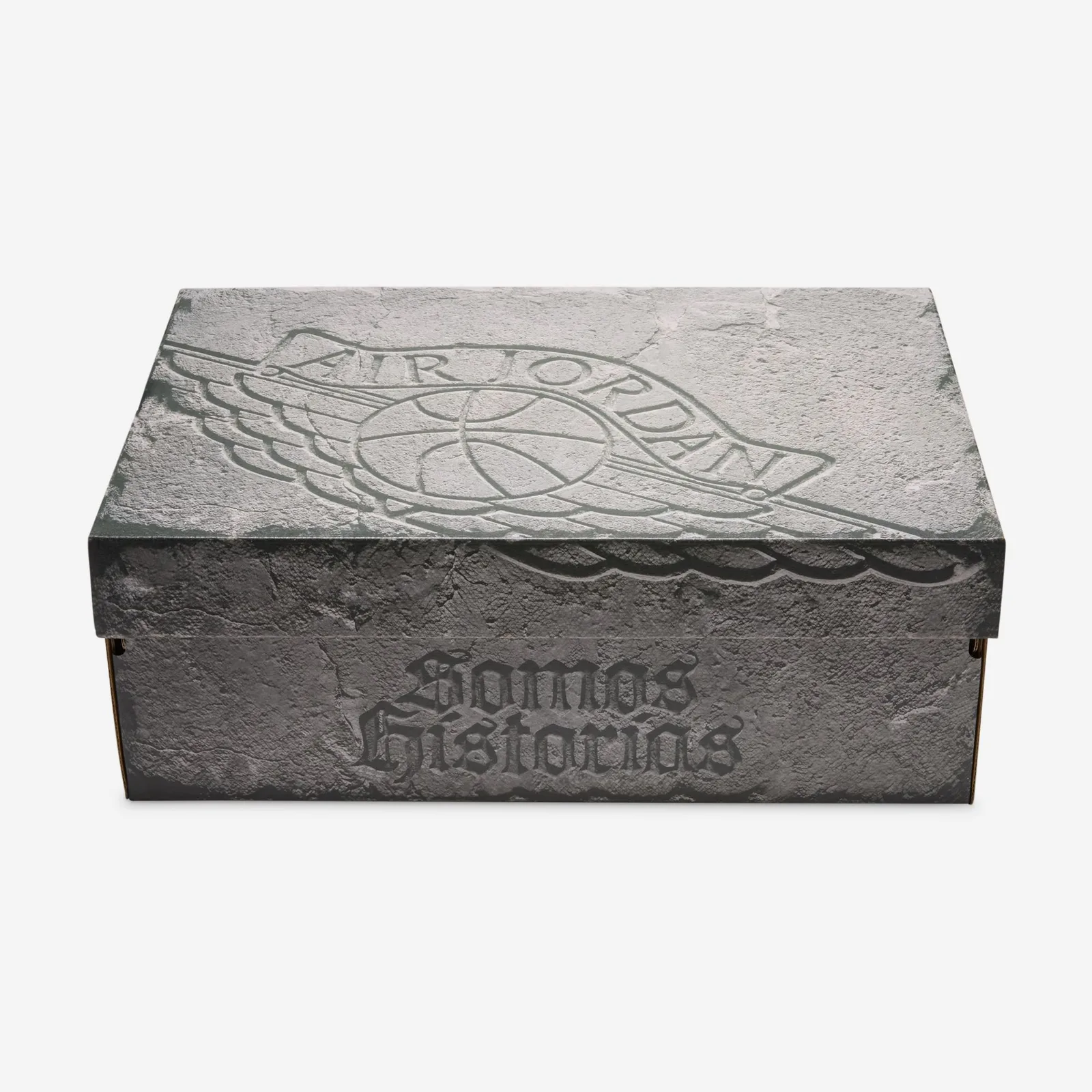 Packaging, grey stone-textured shoe box with embossed wings logo and Somos Historias text, Somos Historias