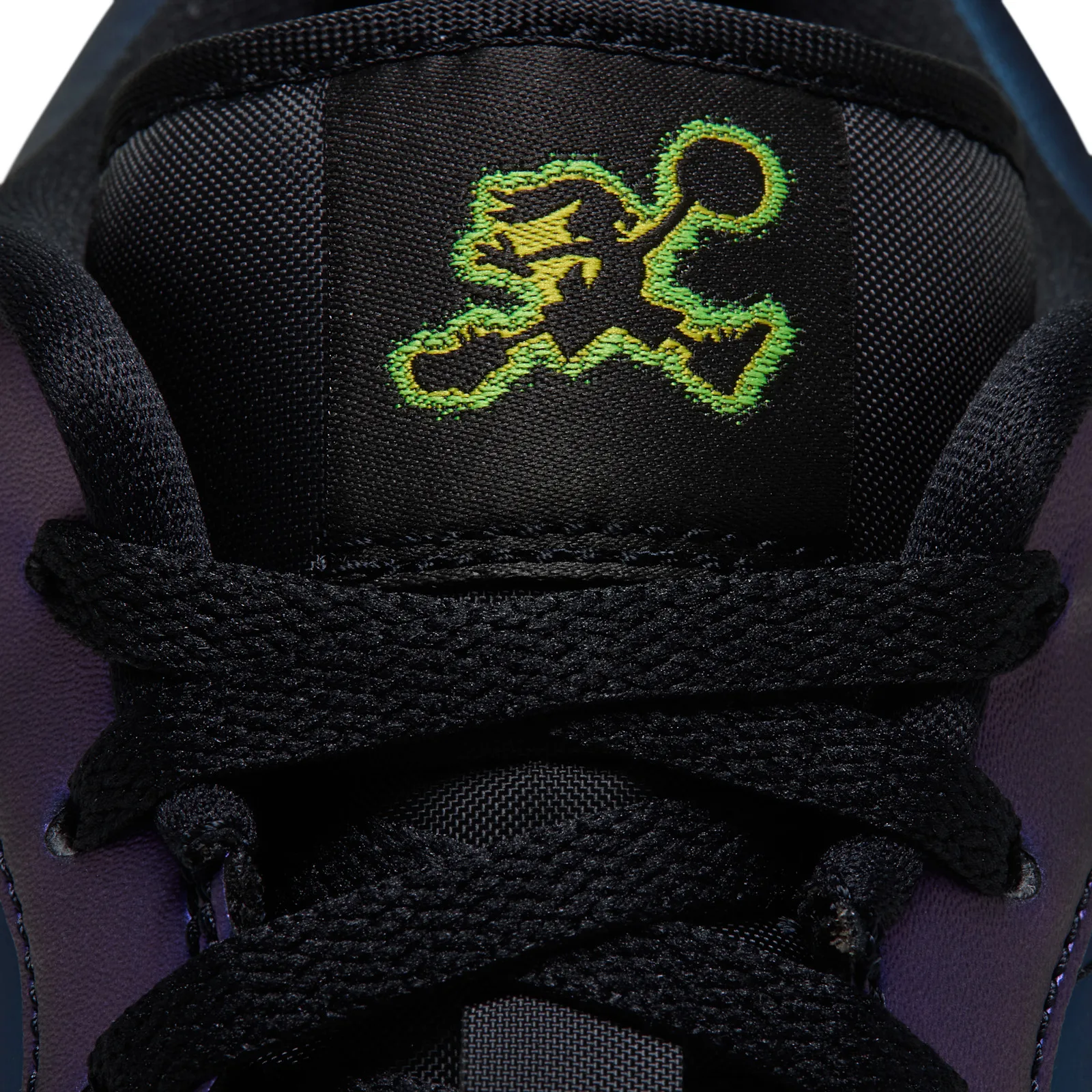 Close detail of tongue label with neon green and yellow cartoon Jumpman, black laces, Air Bugs