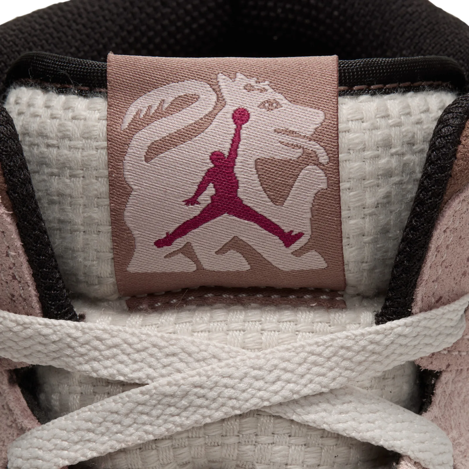 Detail of tongue tag with creature and red jumpman, cream woven tongue, cream laces, Dia de Los Muertos