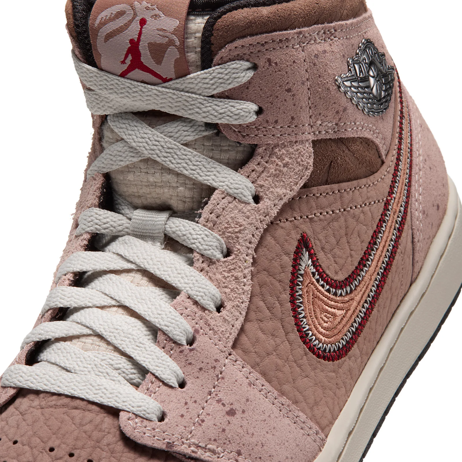 Detail of lace area and ankle, silver wings badge, red and peach stitched swoosh on pebbled leather, Dia de Los Muertos
