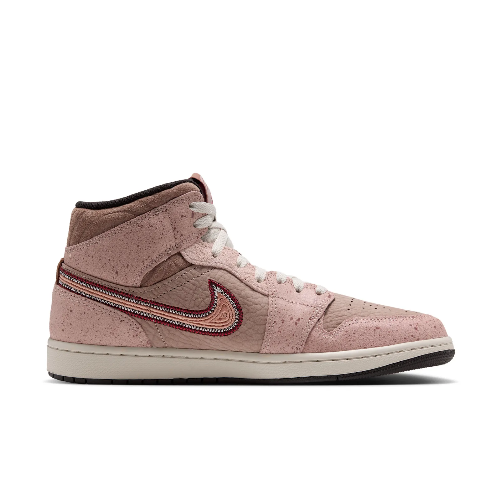 Medial view on white, embroidered swoosh near the heel, speckled pink suede, black collar lining, Dia de Los Muertos