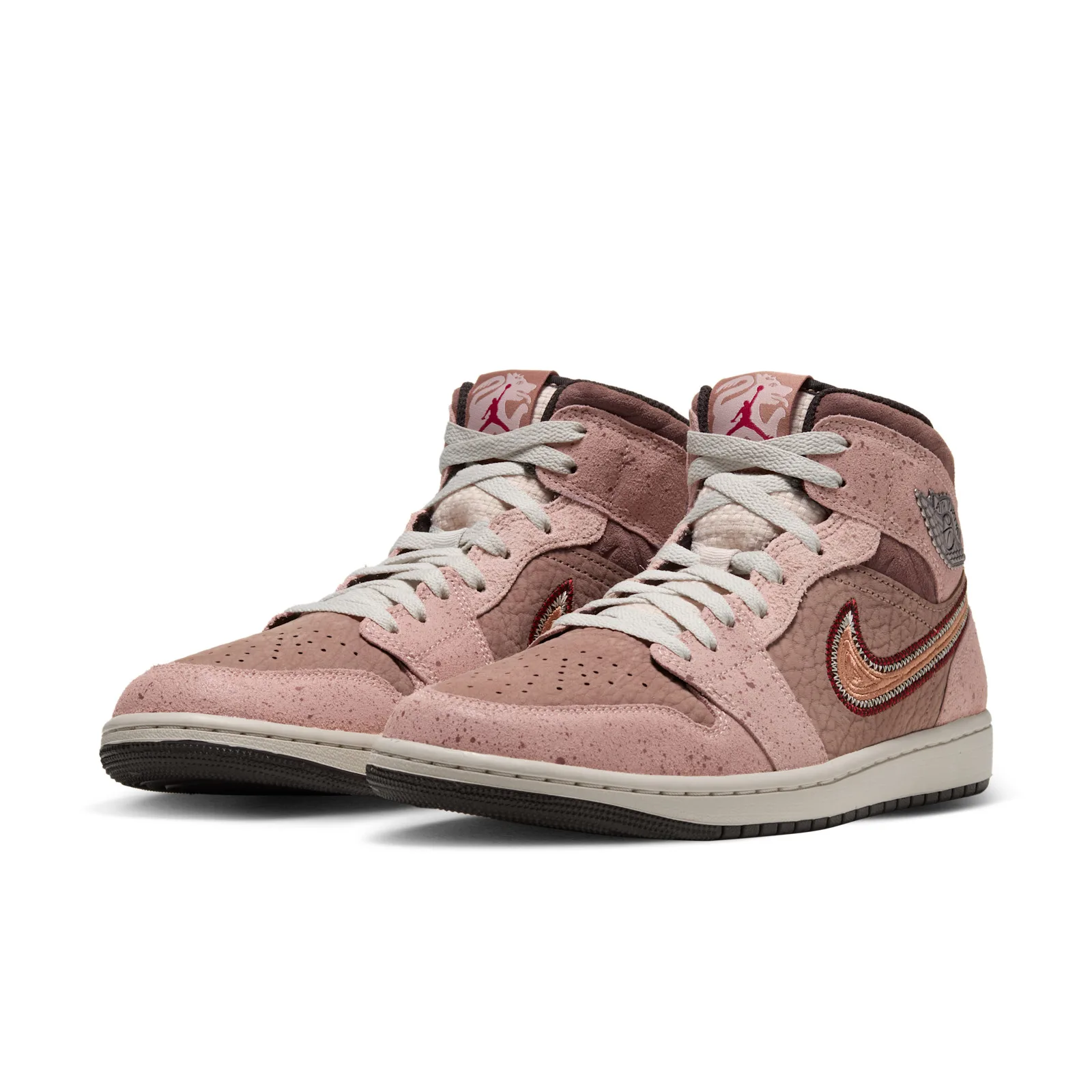 Pair angled front view, pink speckled suede, cream laces, jumpman and creature graphic on tongues, Dia de Los Muertos