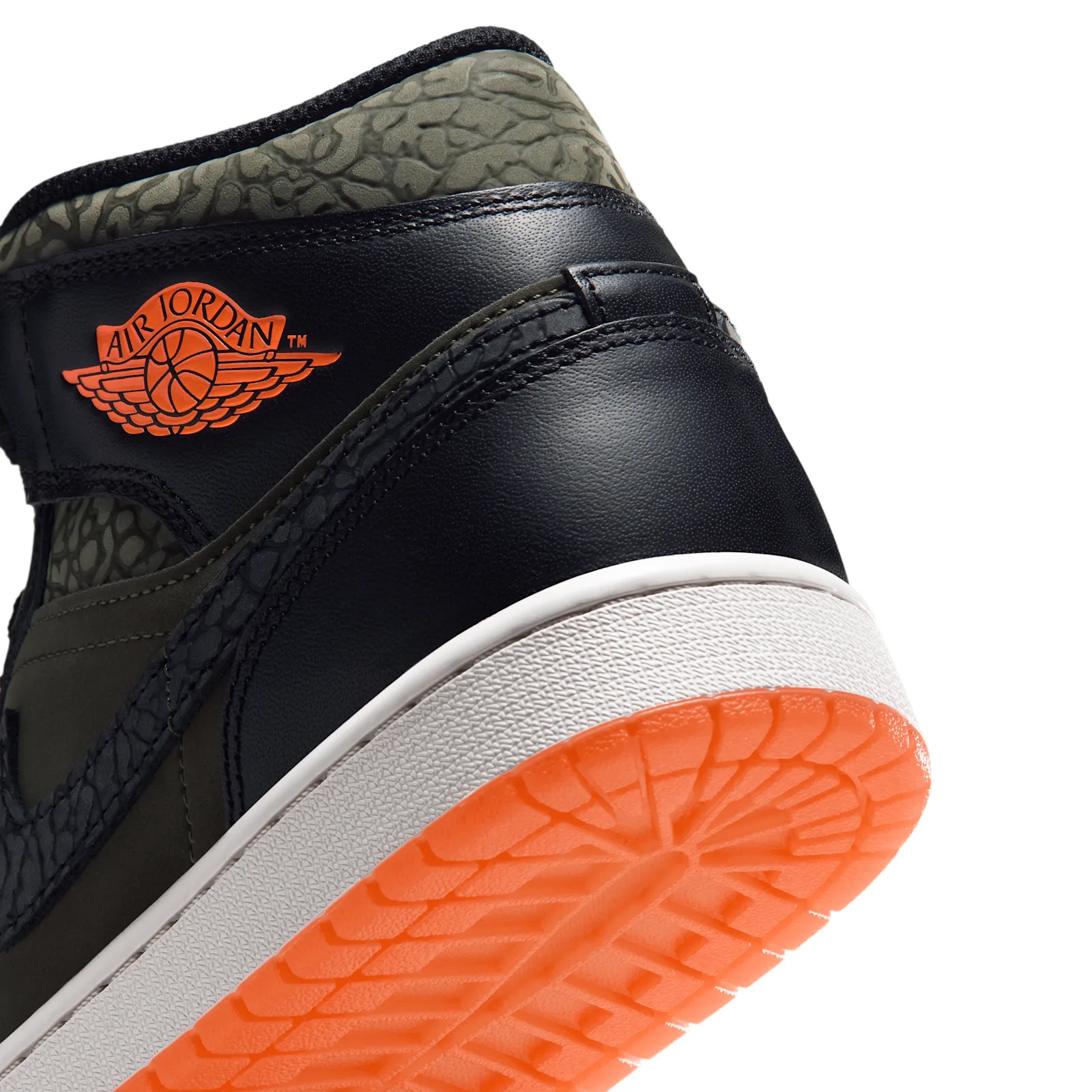 Detail of heel, orange Air Jordan wings logo, elephant-print collar, orange outsole, Flight Jacket