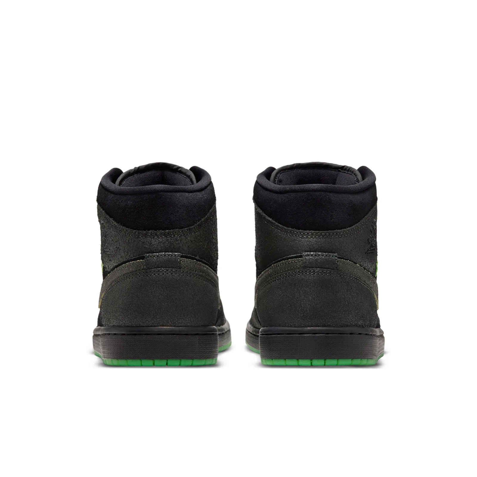 Heel view of pair with textured dark grey panels and green outsoles, Halloween