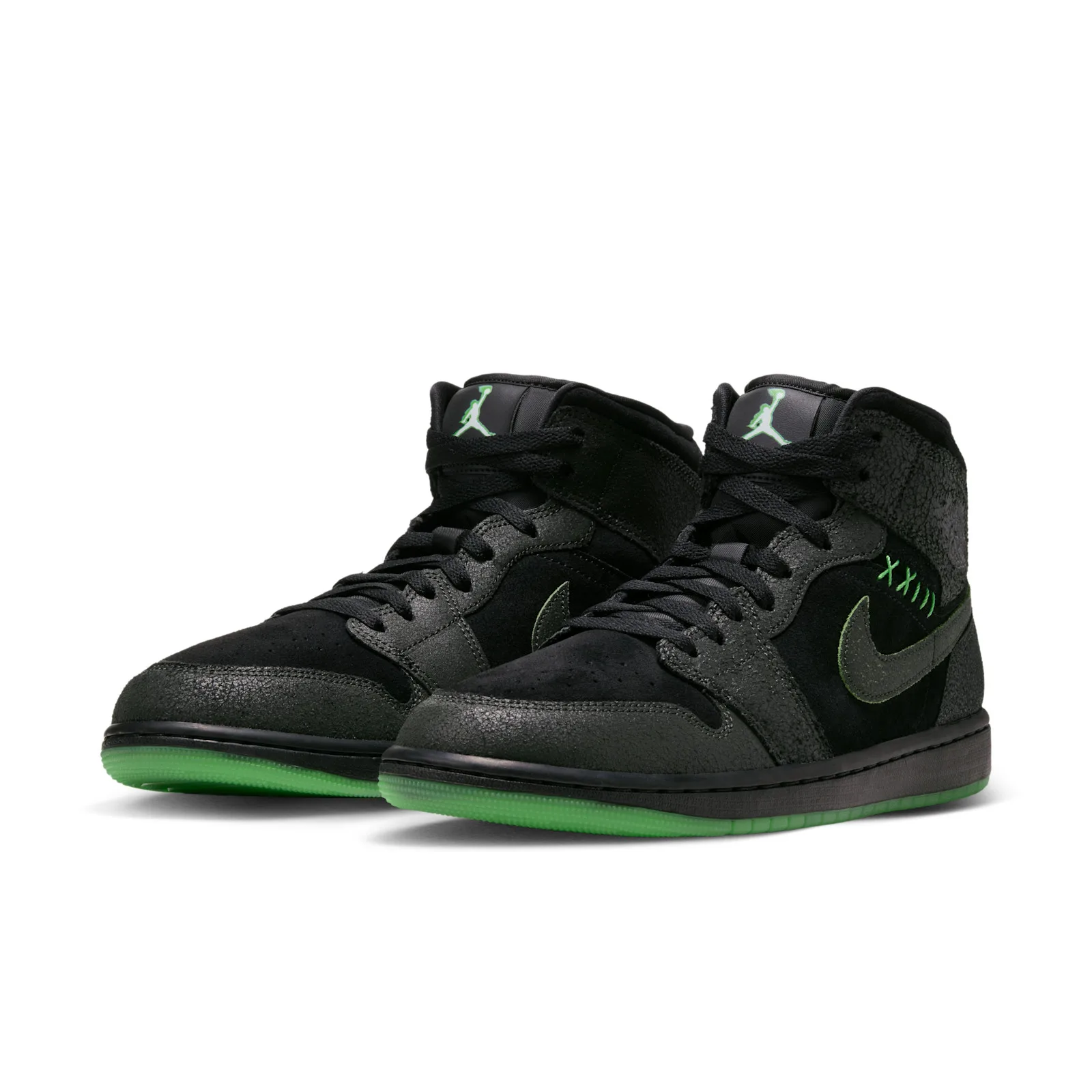 Pair at a front angle with black uppers and bright green outsoles, Halloween