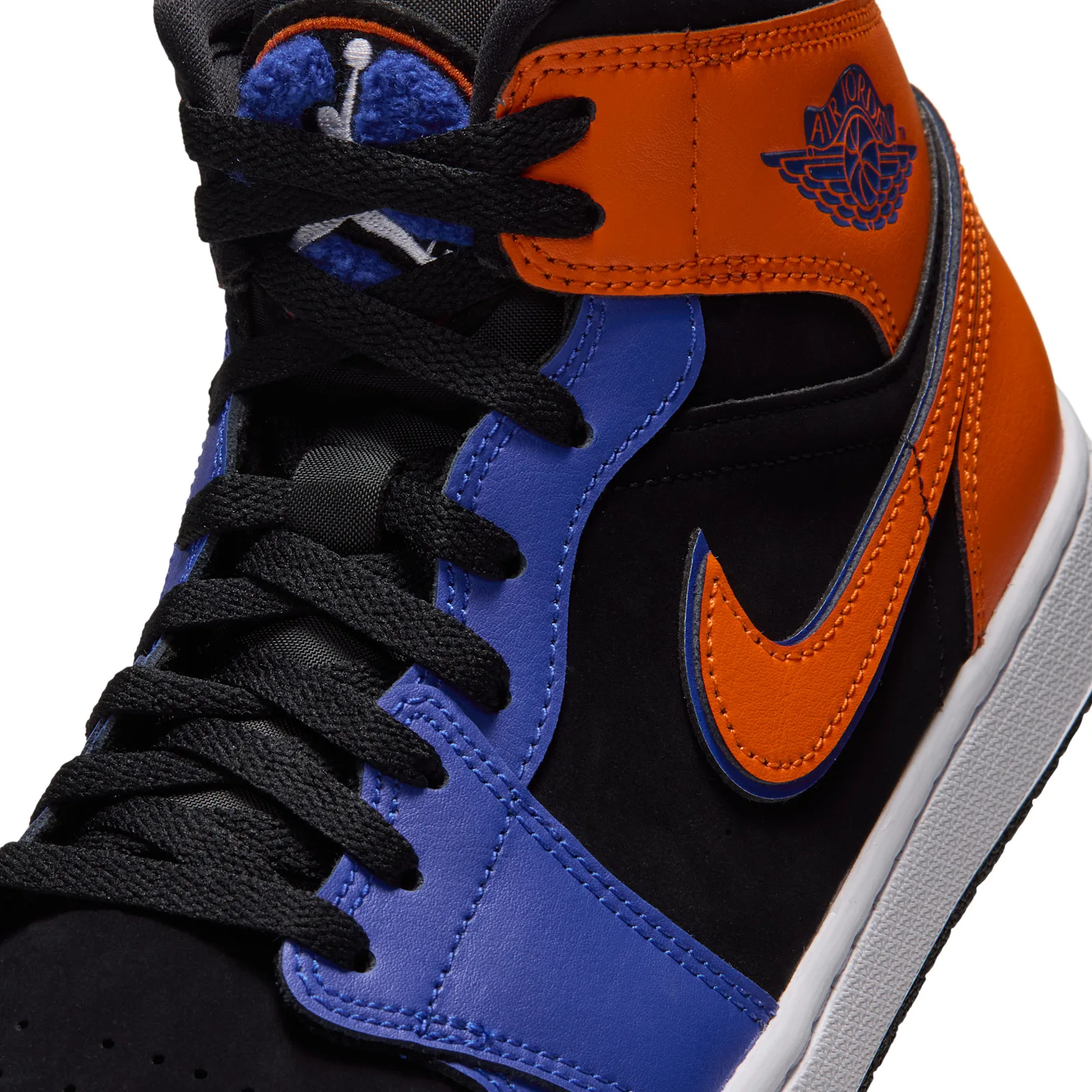 Detail of lacing and ankle, blue chenille tongue patch, orange swoosh and wings logo, Knicks