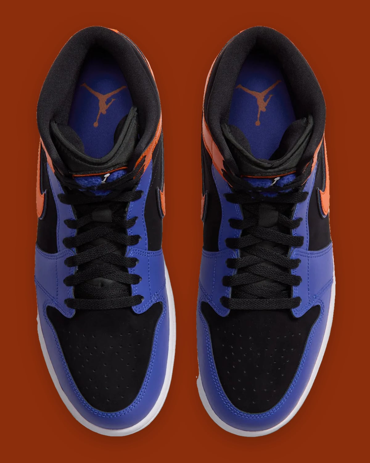Top-down view of pair, black laces, blue insoles with orange Jumpman logo, Knicks