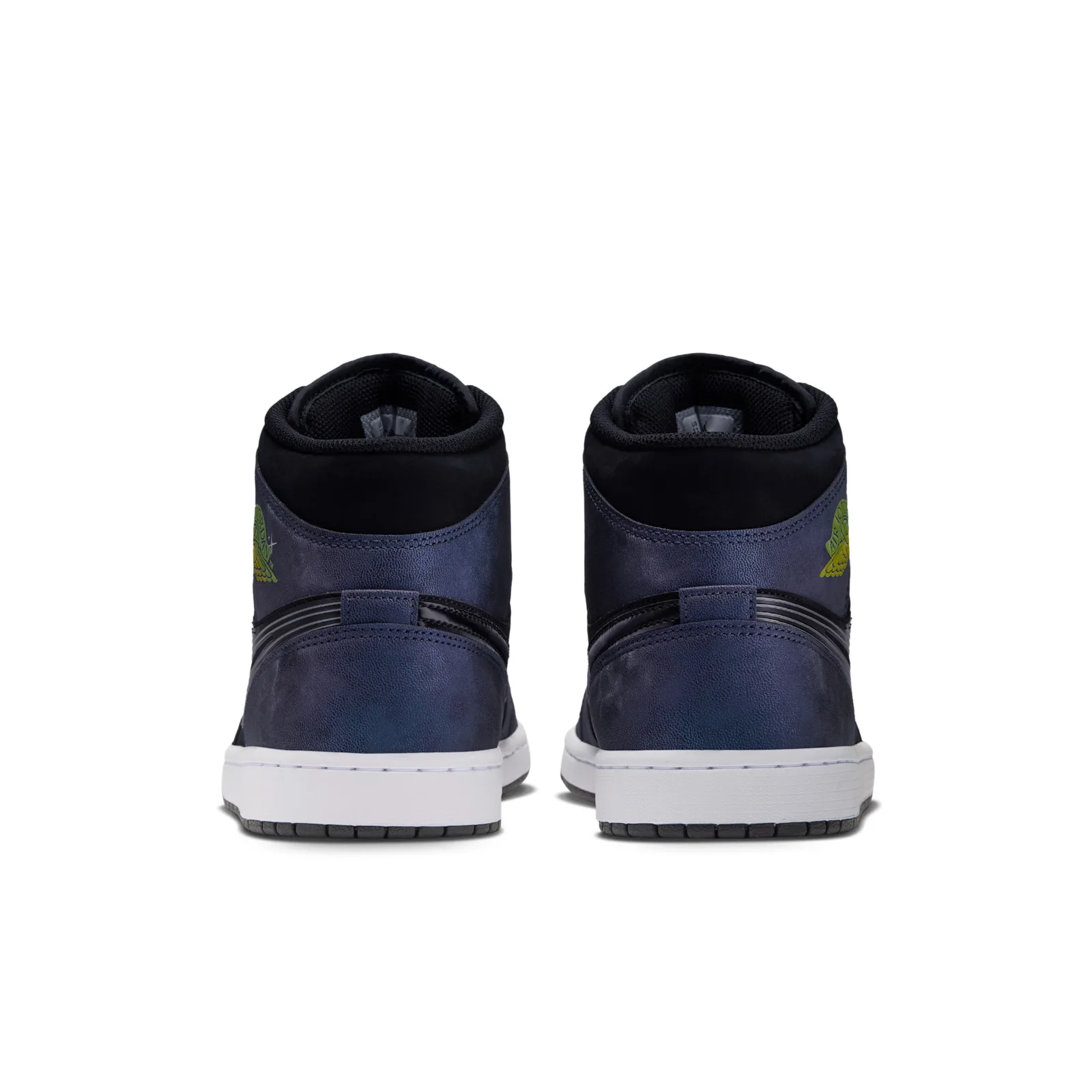Heel view of pair, navy heel panels, green-yellow wings logo, white midsole, Air Bugs