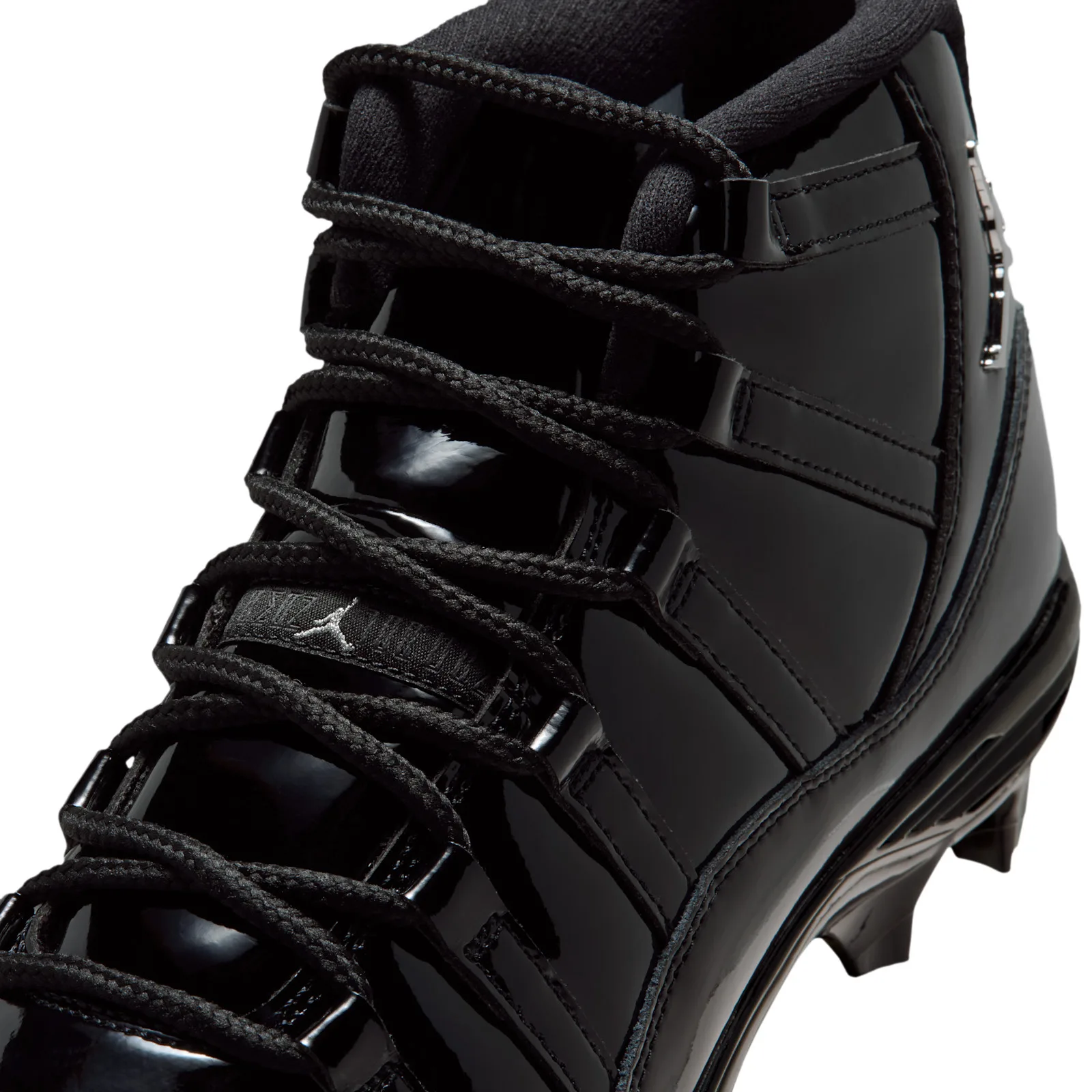 Detail of lace area, black laces on glossy patent overlays, small Jumpman logo on the lace tab, Gammas
