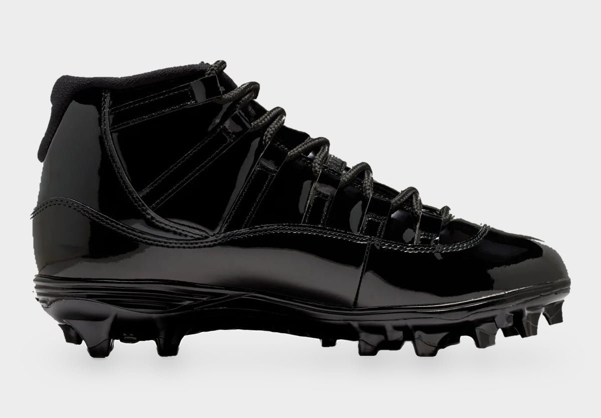 Medial view of black patent leather cleat with black laces and molded black studs, Gammas