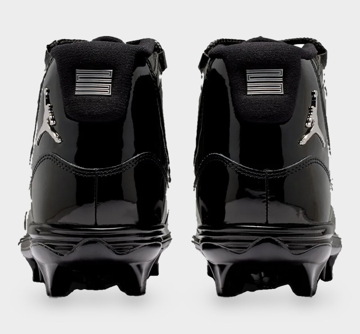 Heel view of pair, silver Jumpman logos and silver striped heel tab on black patent leather, Gammas