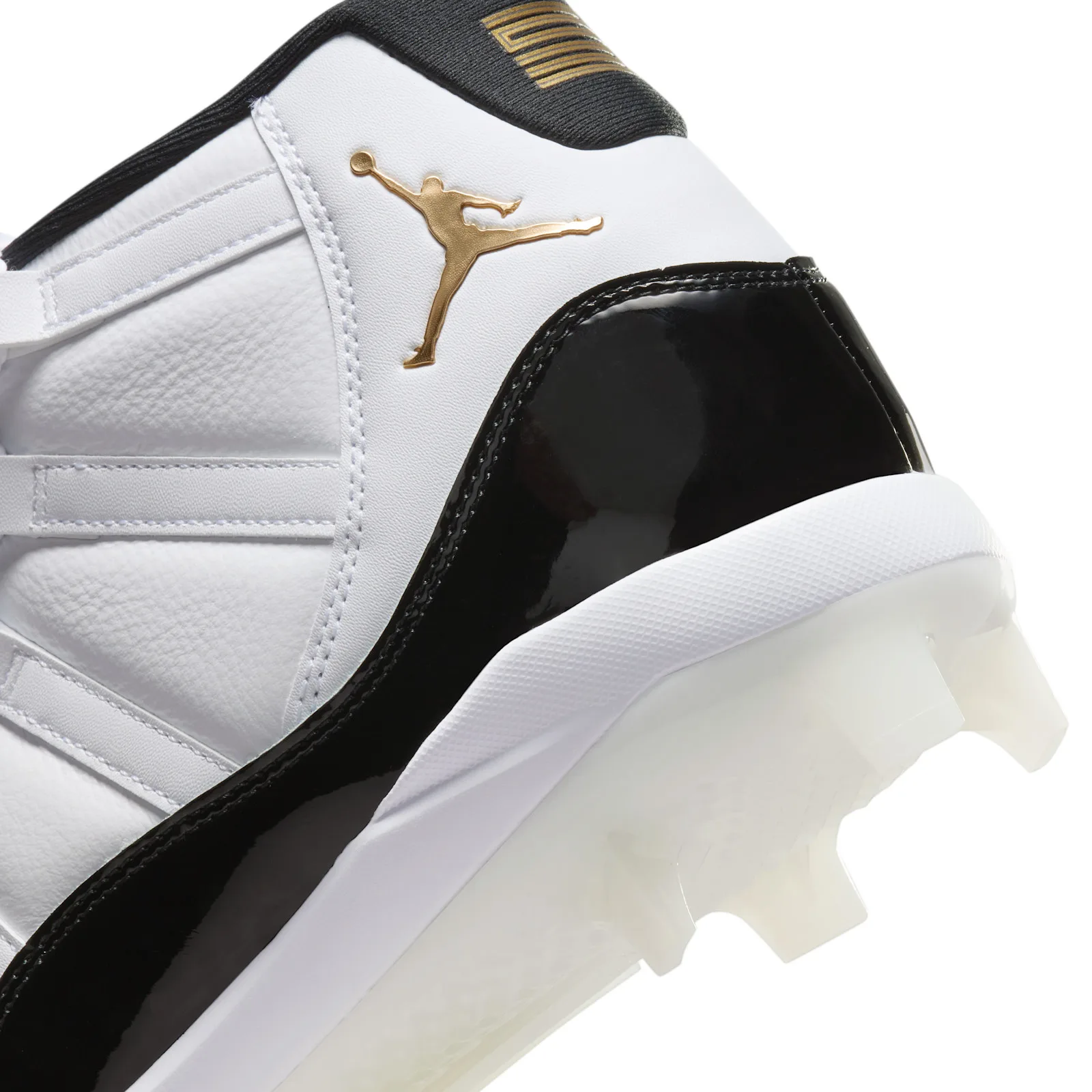 Detail of heel: gold Jumpman on white leather, black patent heel counter, gold tab logo, white sole, DMP