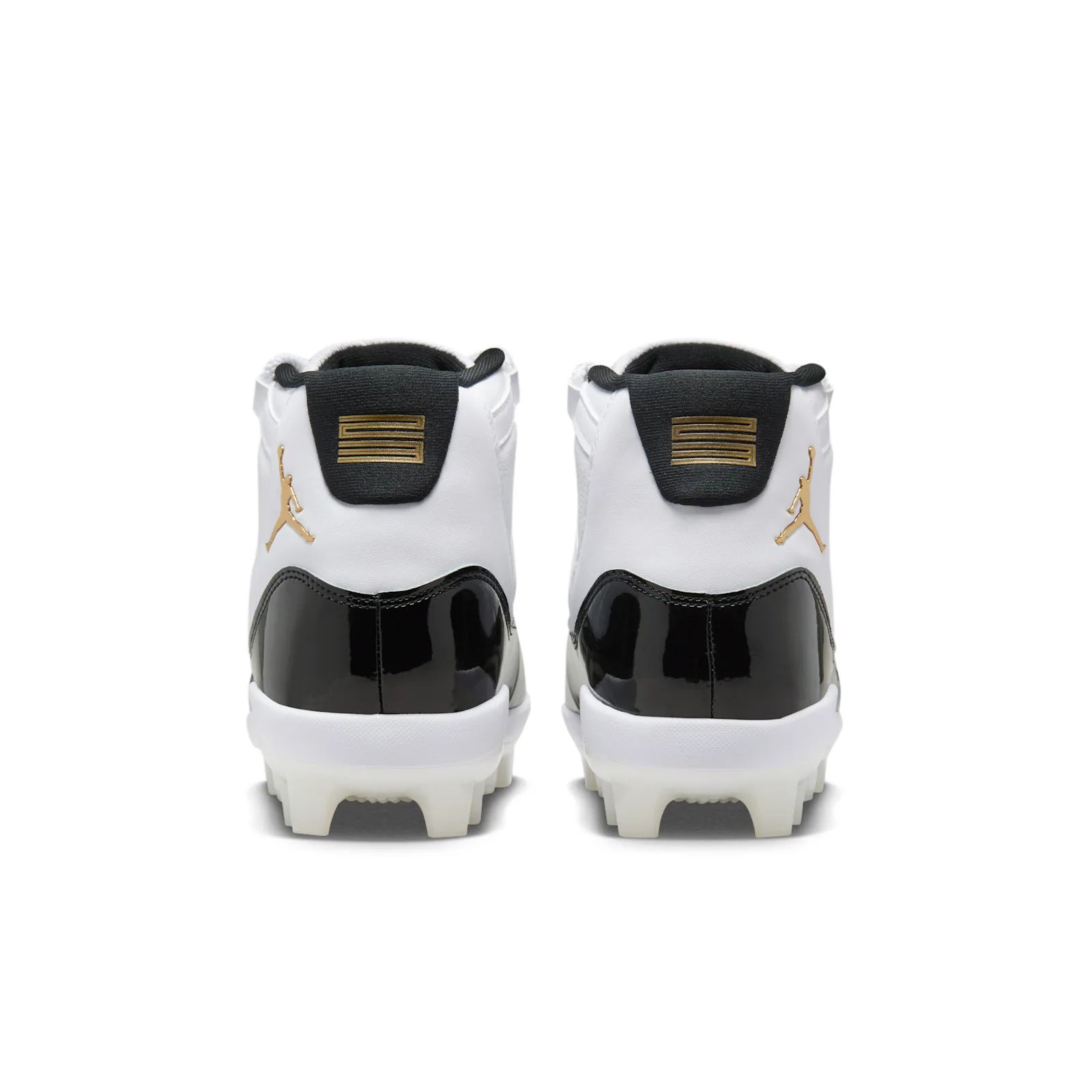 Heel view of pair: black heel tabs with gold embossed 11 logos and gold Jumpman on white upper, DMP