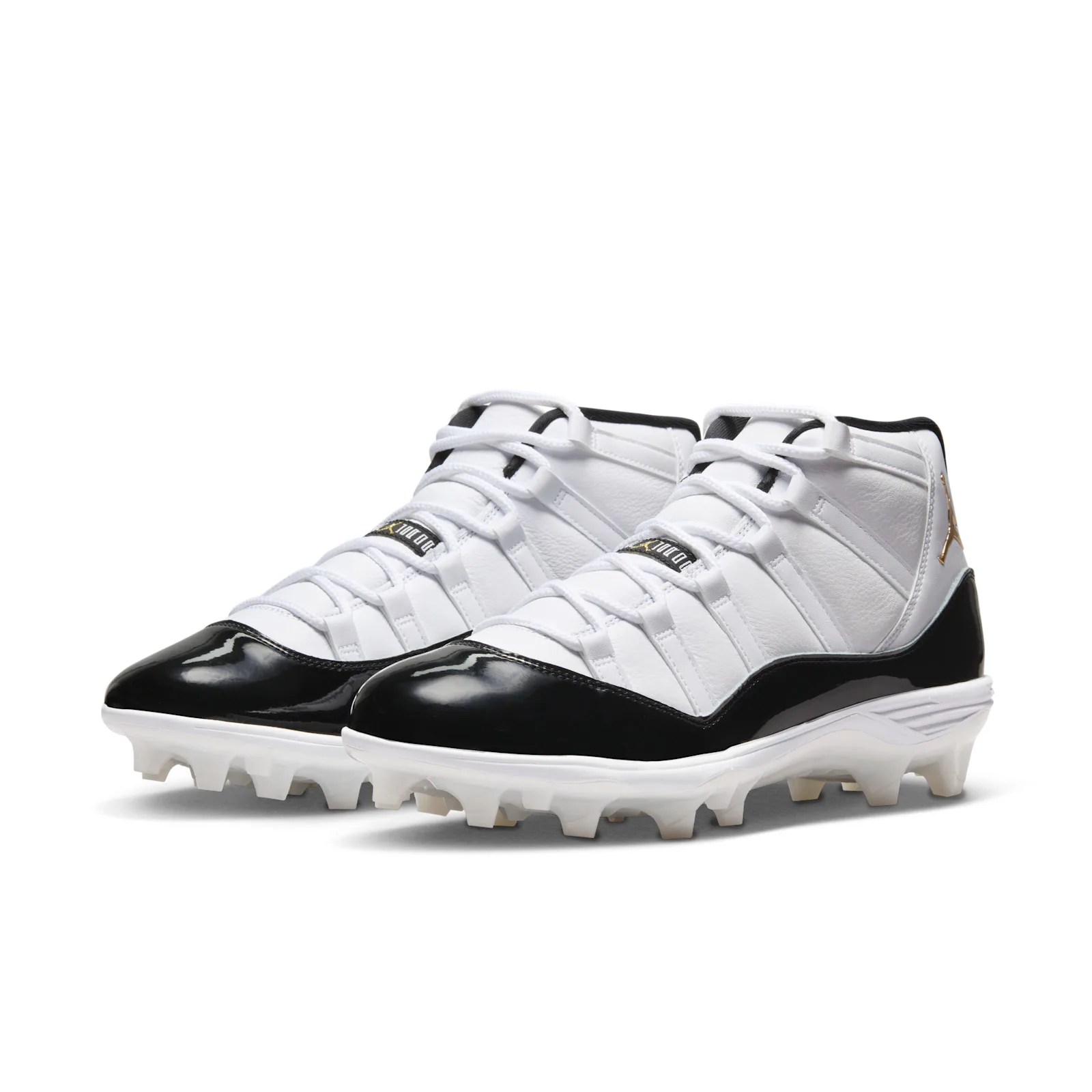 Pair at three-quarter angle, white laced uppers, glossy black patent toes and white studded cleat soles, DMP