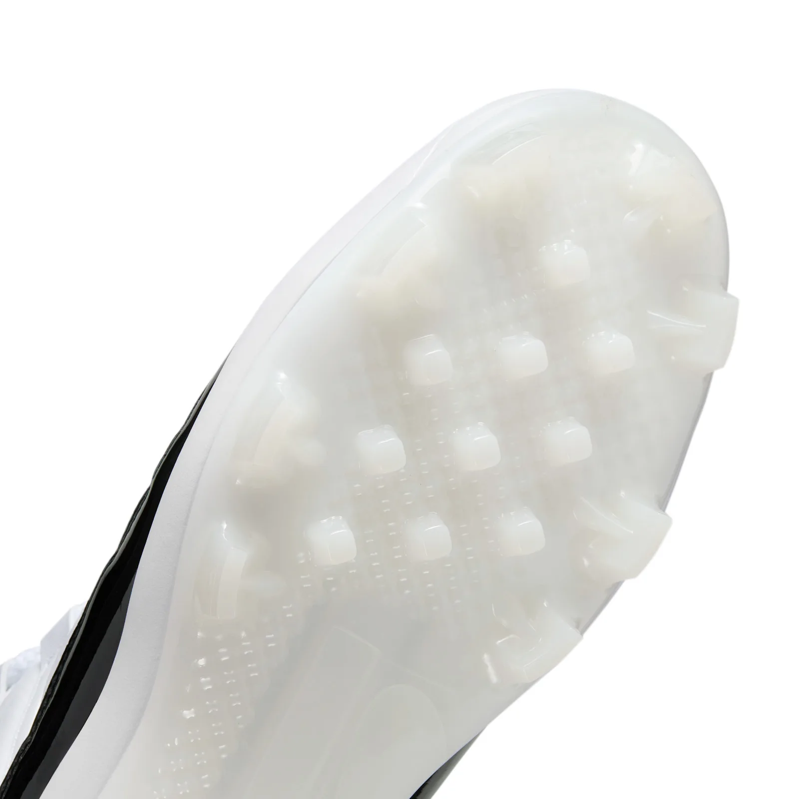 Close-up of translucent white outsole studs in rows, with black patent side and white upper edge, DMP
