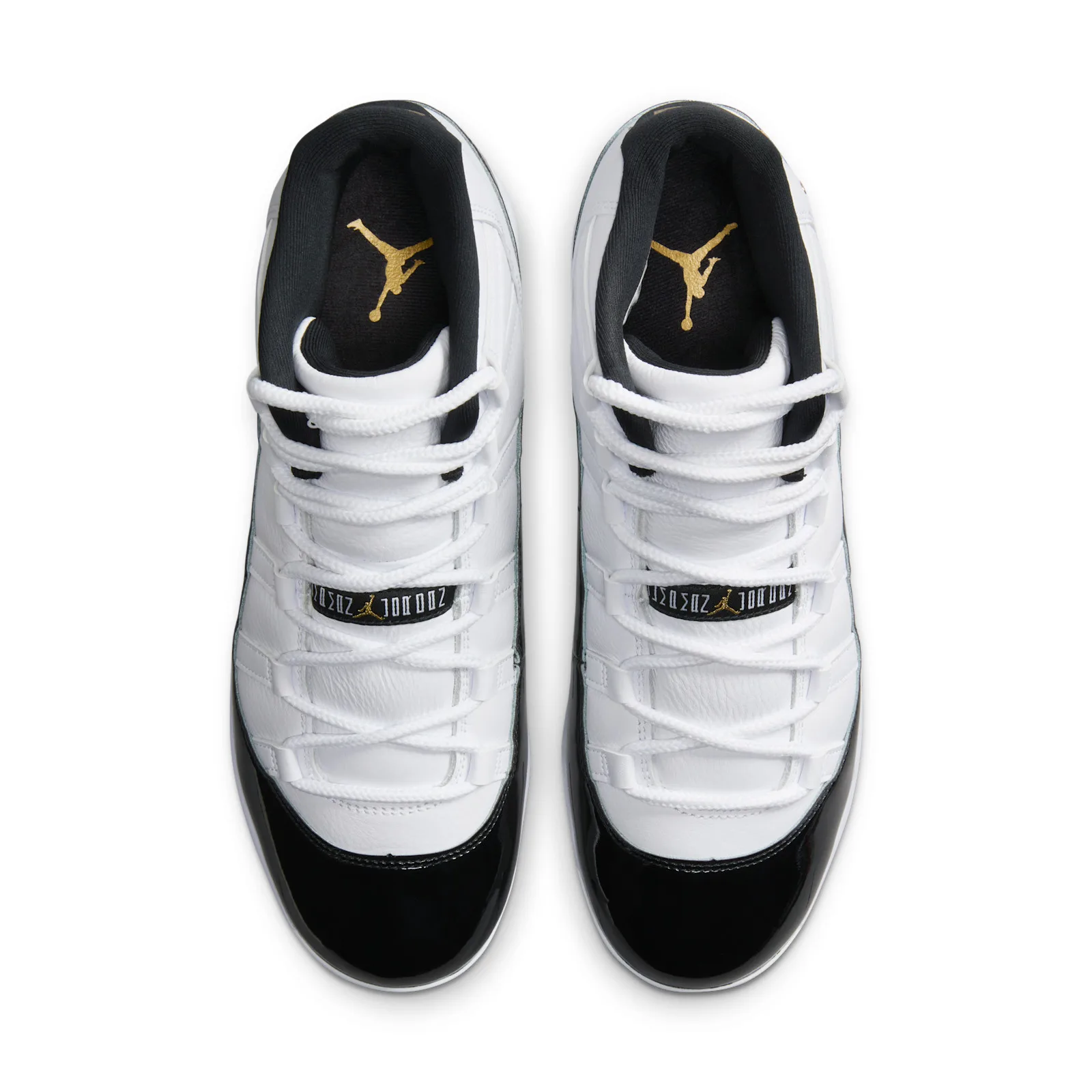Top-down view of pair, white criss-cross laces, black collars, gold Jumpman insoles and black patent toes, DMP